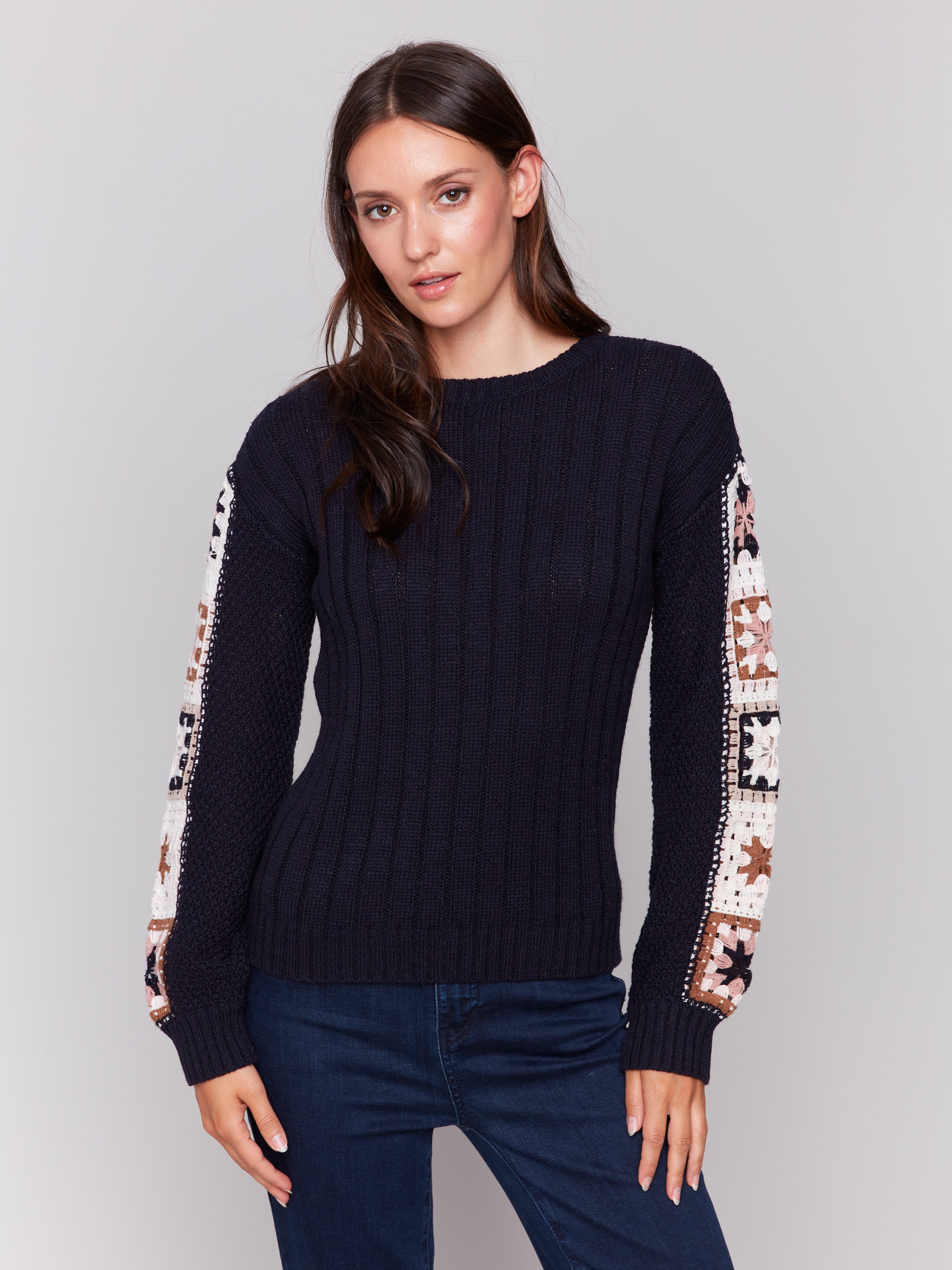 Navy blue long-sleeve sweater with detailed crochet pattern on the sleeves by Charlie B.