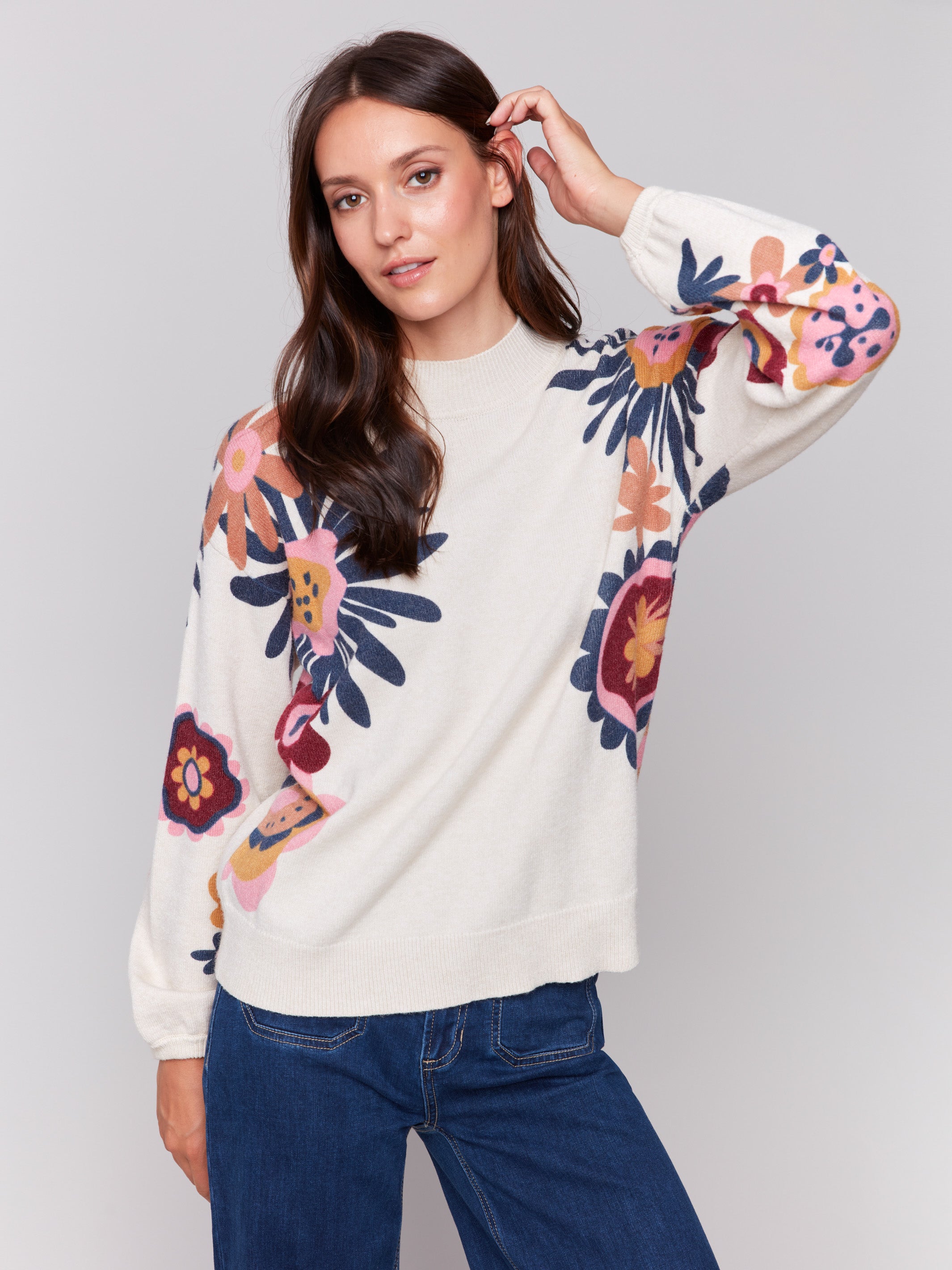 Creamy beige mock neck sweater with vibrant floral print, featuring long sleeves and a cozy knit texture by Charlie B.