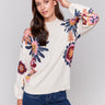 Creamy beige mock neck sweater with vibrant floral print, featuring long sleeves and a cozy knit texture by Charlie B.