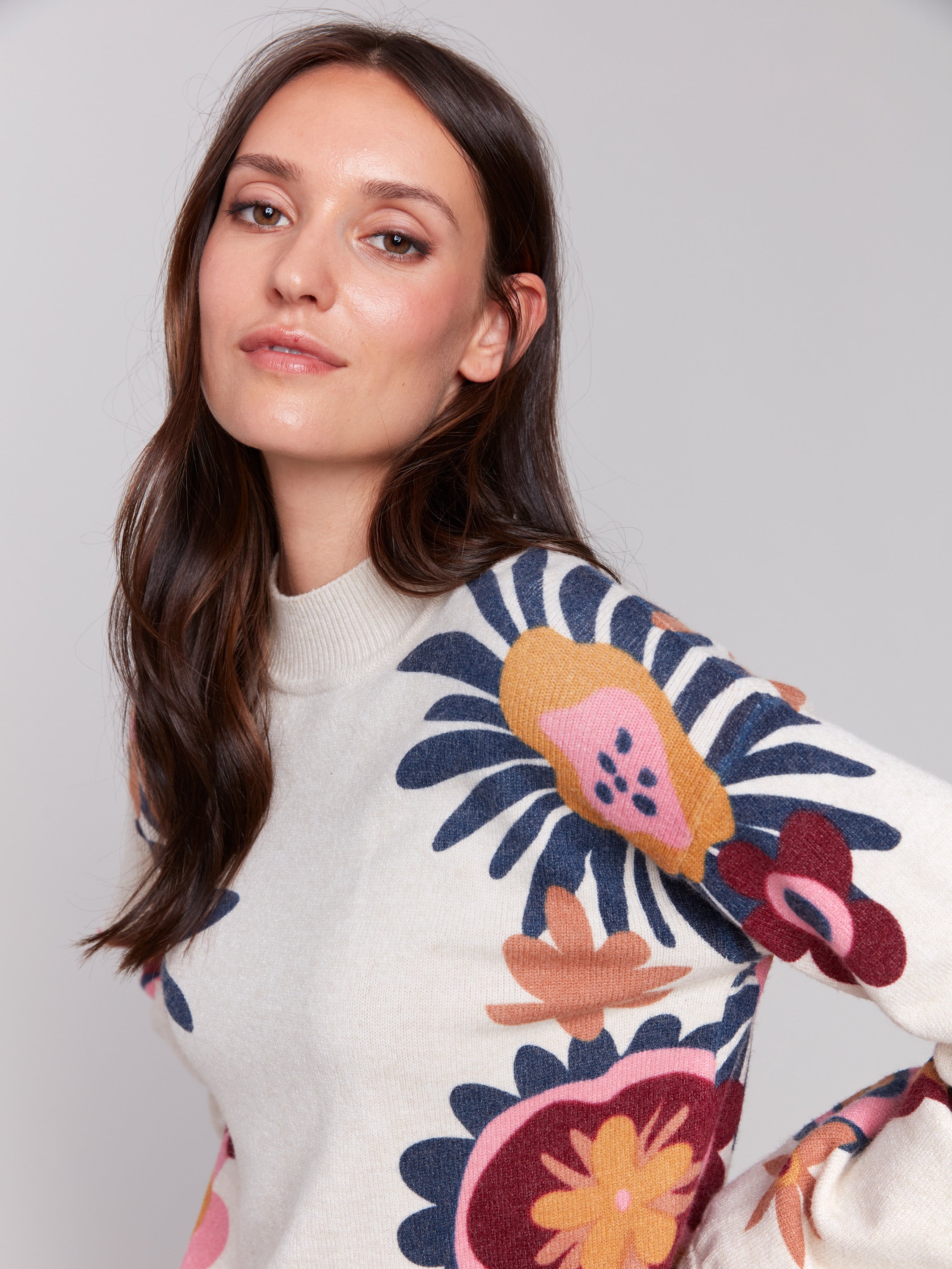 Creamy beige mock neck sweater with vibrant floral print, featuring long sleeves and a cozy knit texture by Charlie B.