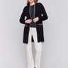 Black long cardigan with white blanket stitch trim, featuring patch pockets and an open front by Charlie B.