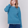 Peacock blue sweater featuring blanket stitch detailing along the crew neckline, cuffs, and hem, by Charlie B.