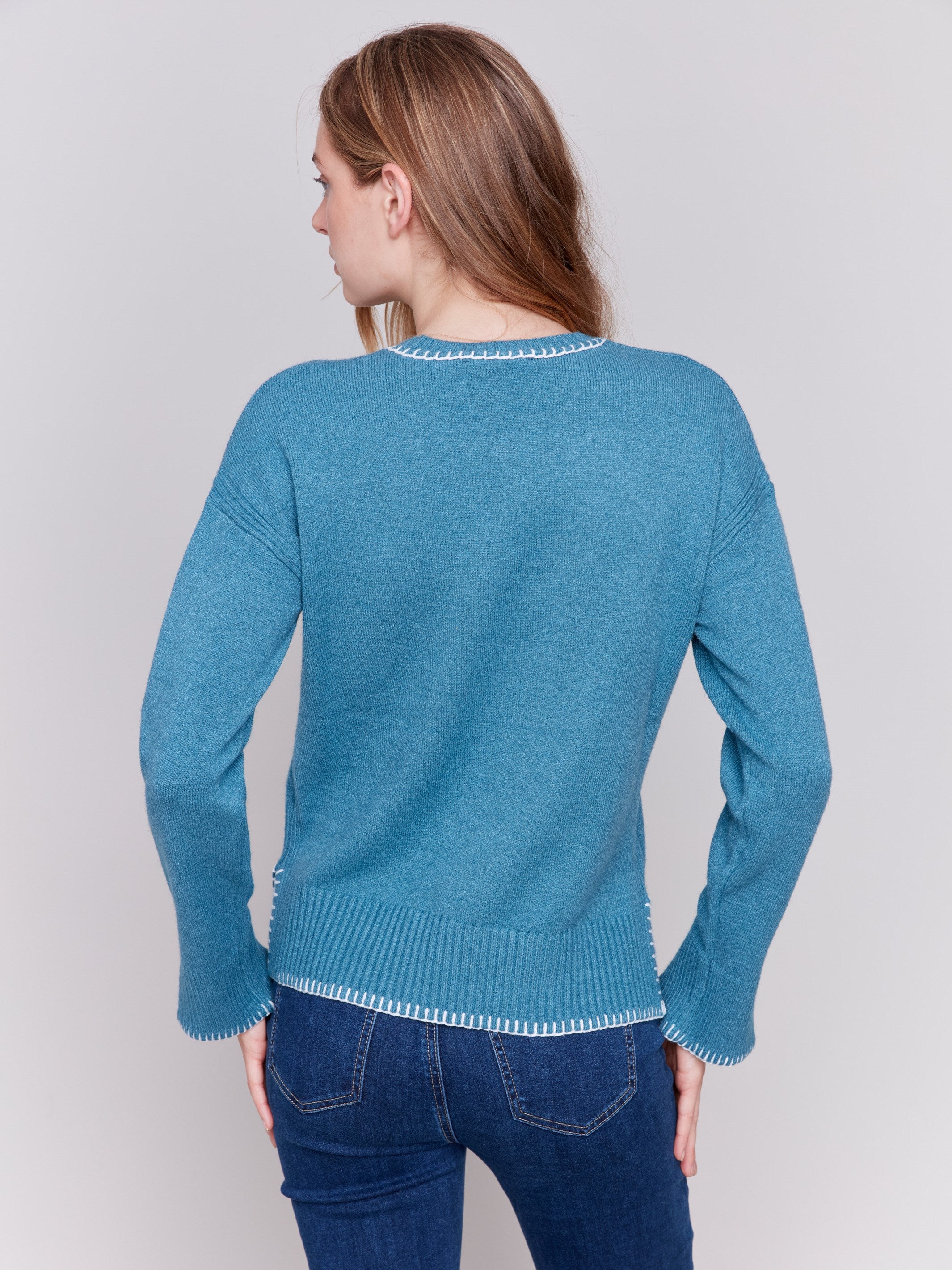 Peacock blue sweater featuring blanket stitch detailing along the crew neckline, cuffs, and hem, by Charlie B.