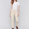 Natural-colored bootcut corduroy pants with an asymmetrical frayed hem and a bootcut fit by Charlie B.