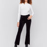 Black bootcut corduroy pants with an asymmetrical frayed hem and a bootcut fit by Charlie B.