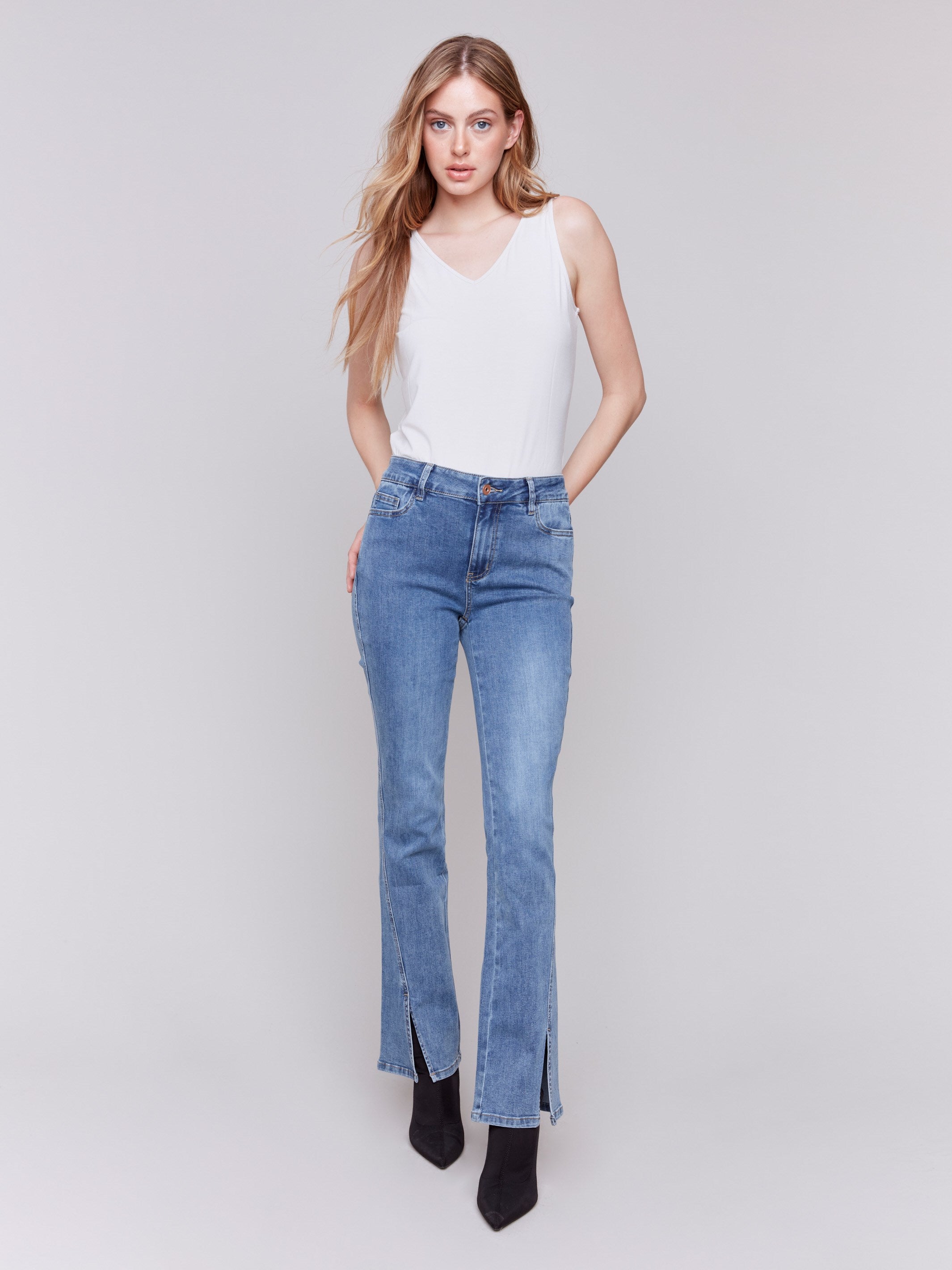 Medium blue bootcut jeans with front slits, regular rise and five-pocket design by Charlie B.