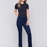 Dark blue-black bootcut jeans with gem buttons and a raw edge hem, featuring a five-pocket design by Charlie B.