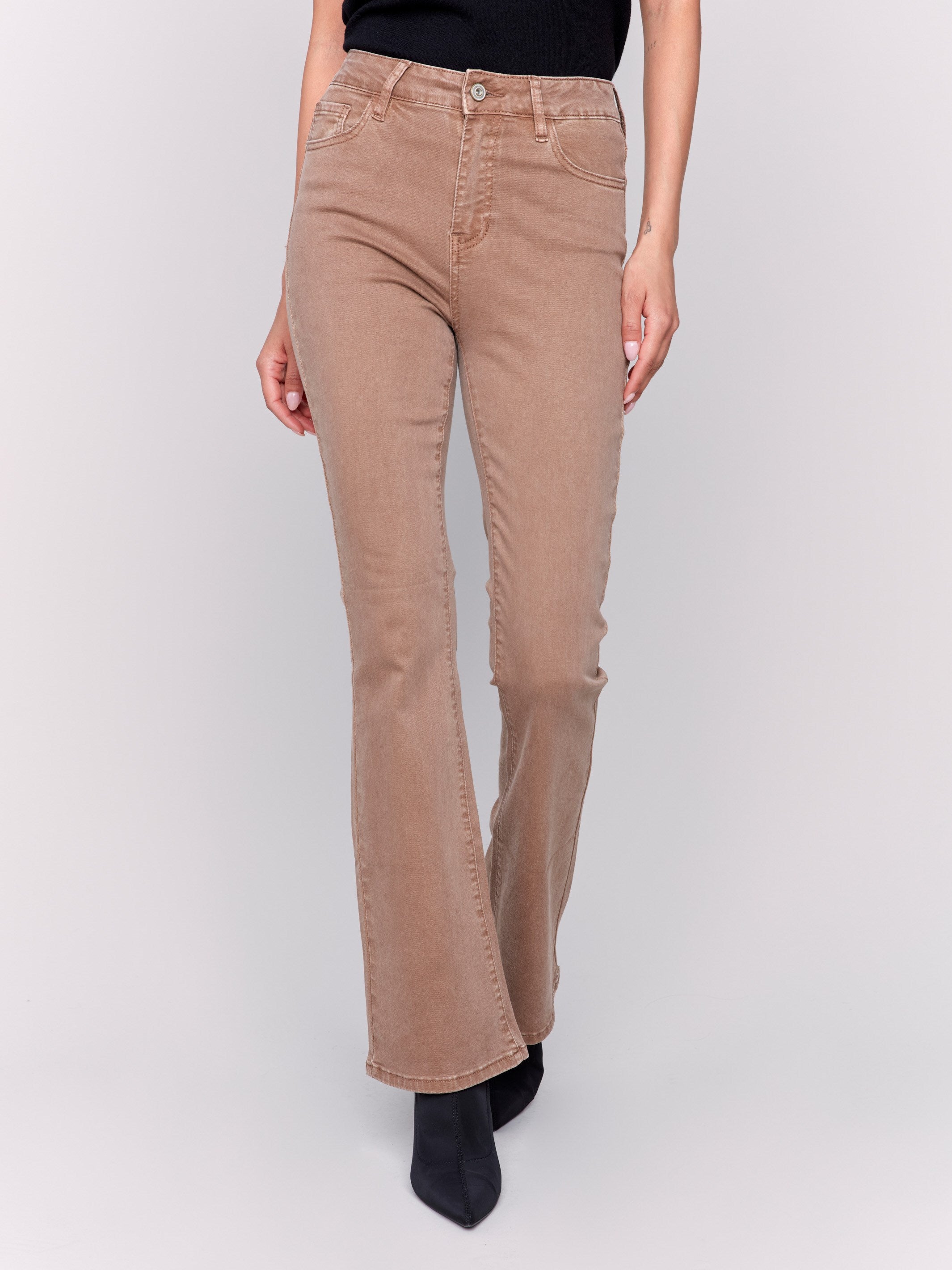 Brown bootcut twill pants with a mid-rise and bootcut fit, showcasing five-pocket design by Charlie B.