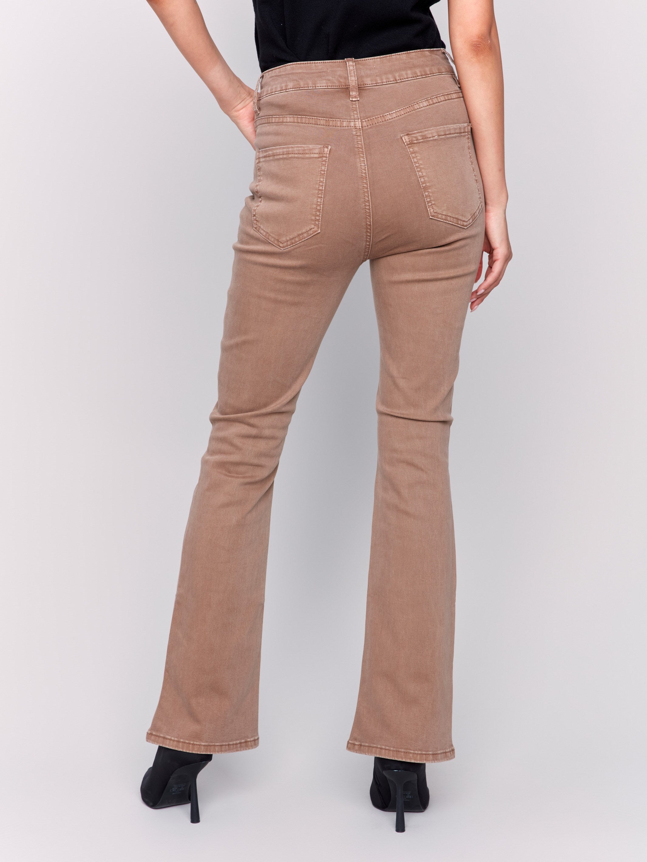 Brown bootcut twill pants with a mid-rise and bootcut fit, showcasing five-pocket design by Charlie B.