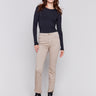 Almond beige bootcut twill pants with an asymmetrical fringe hem and mid-rise waist by Charlie B.