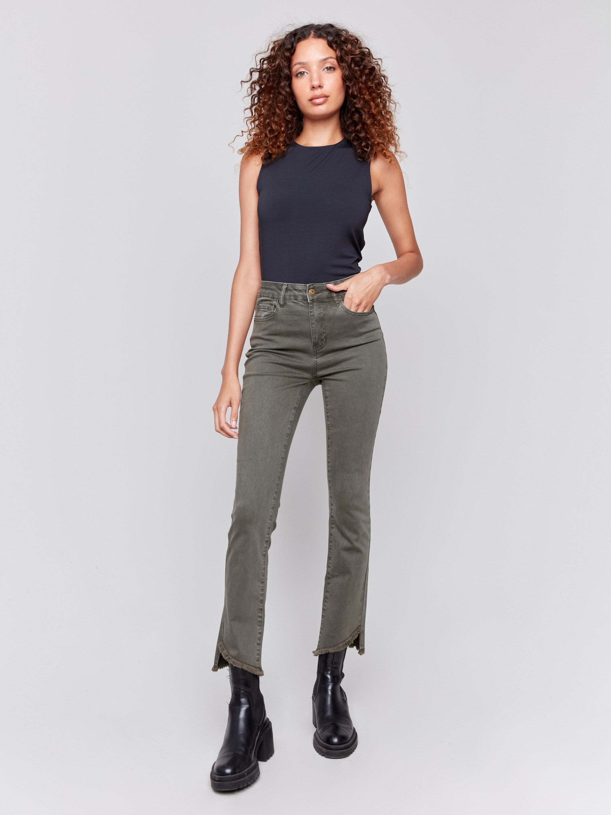 Spruce green bootcut twill pants with an asymmetrical fringe hem and mid-rise waist by Charlie B.