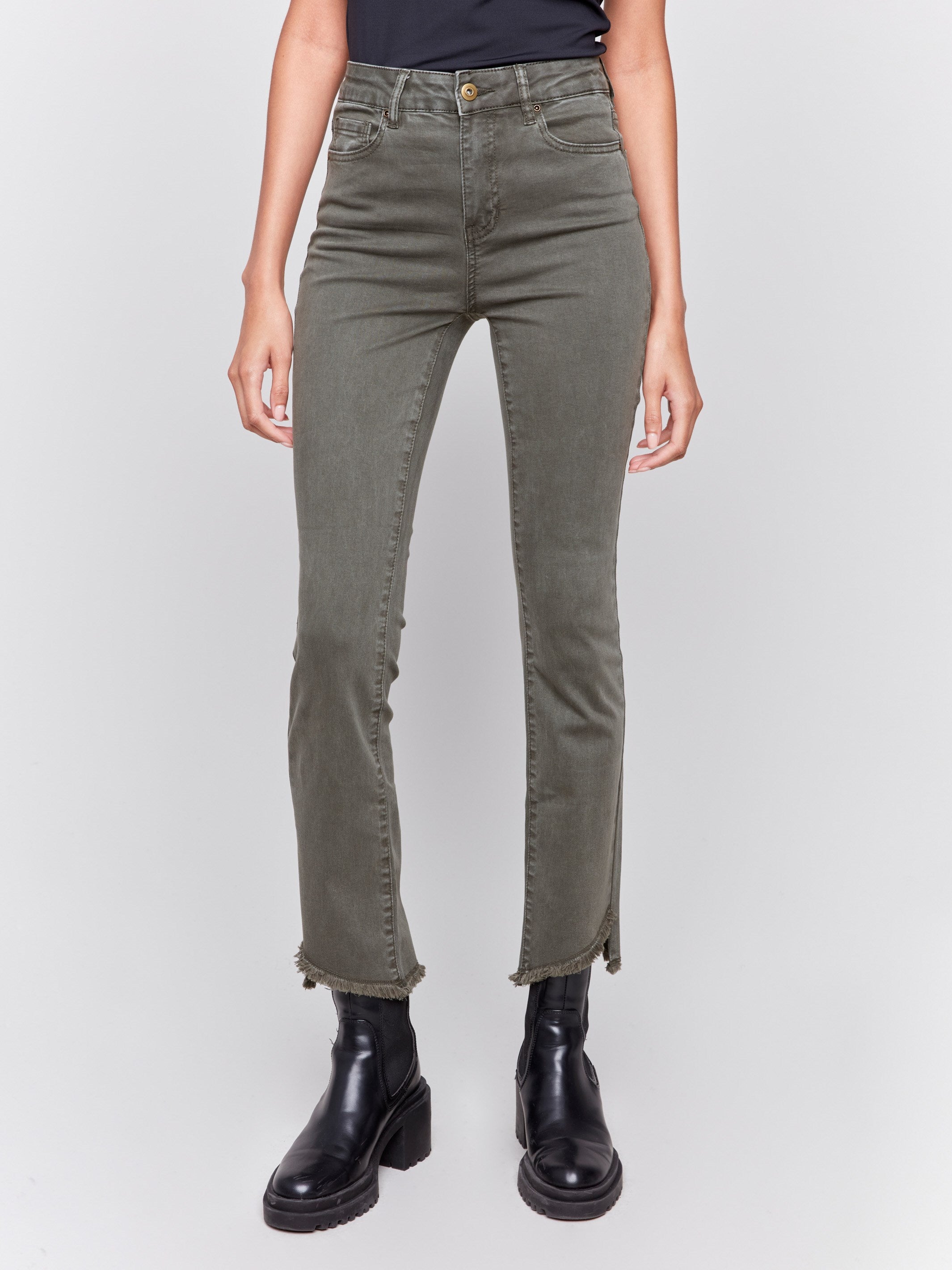 Spruce green bootcut twill pants with an asymmetrical fringe hem and mid-rise waist by Charlie B.