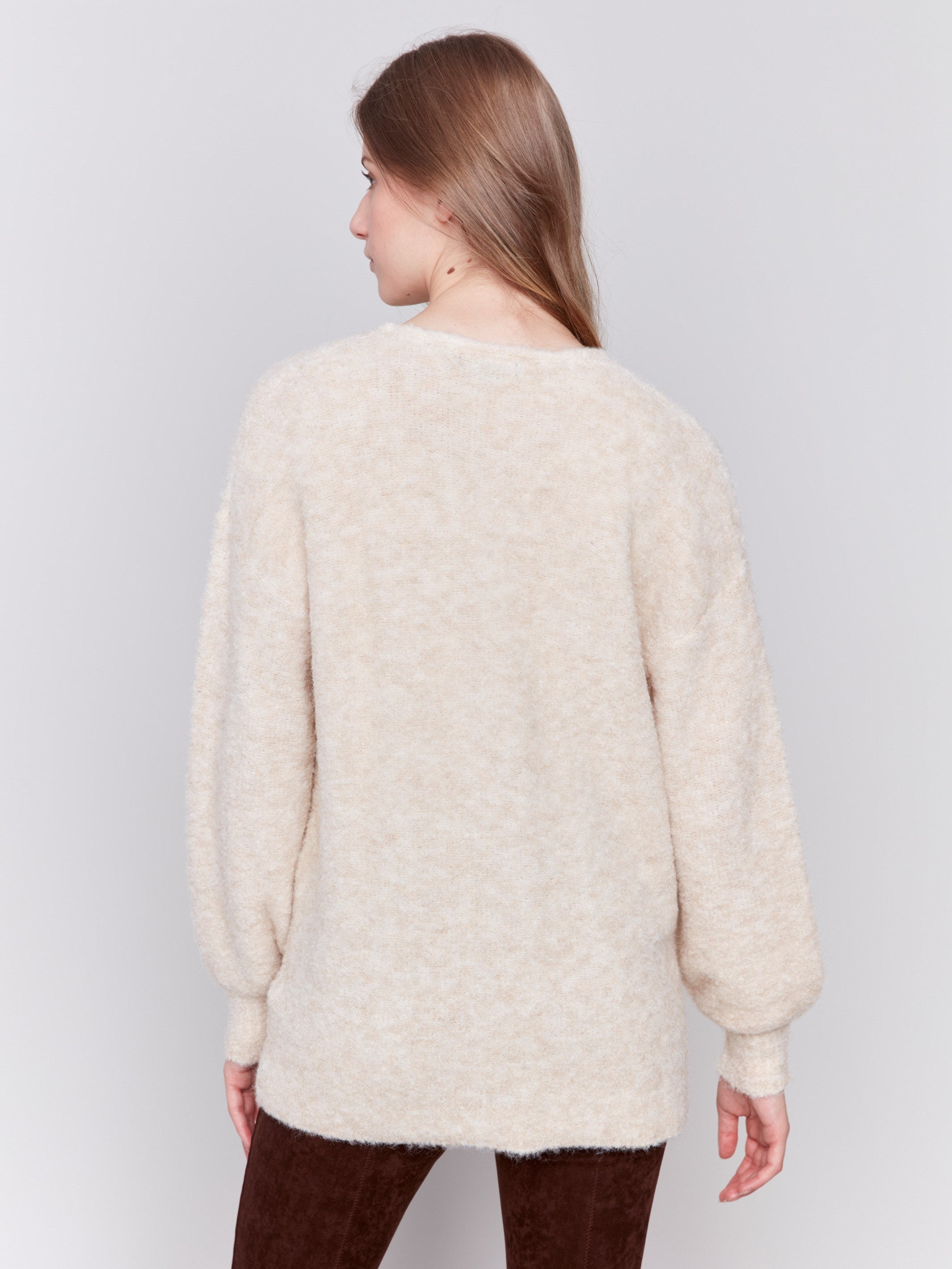 Beige boucle knit cardigan with front button closure and ribbed cuffs by Charlie B.