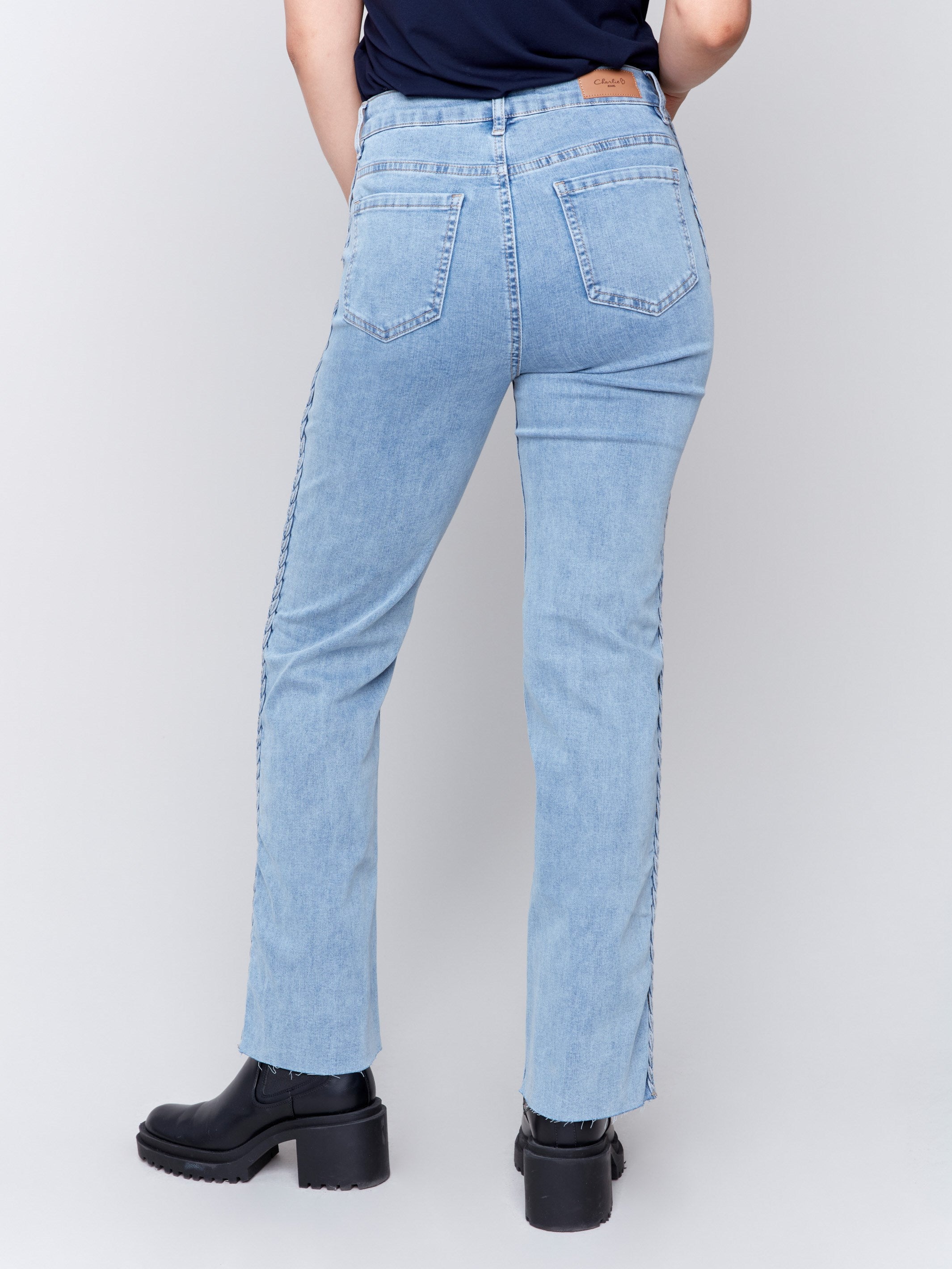 Light blue jeans with braided side seams, regular rise, and straight leg by Charlie B.