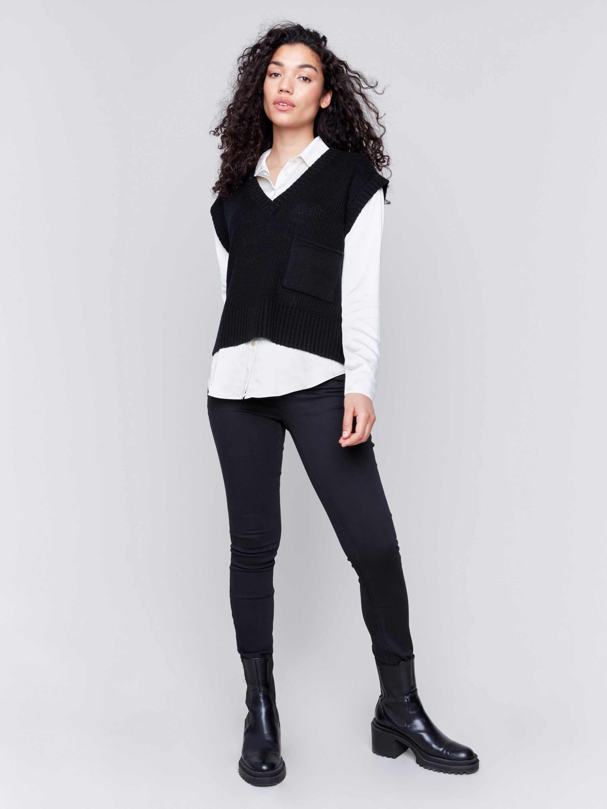 Black soft touch sweater vest with a V-neck and relaxed fit, perfect for layering by Charlie B.