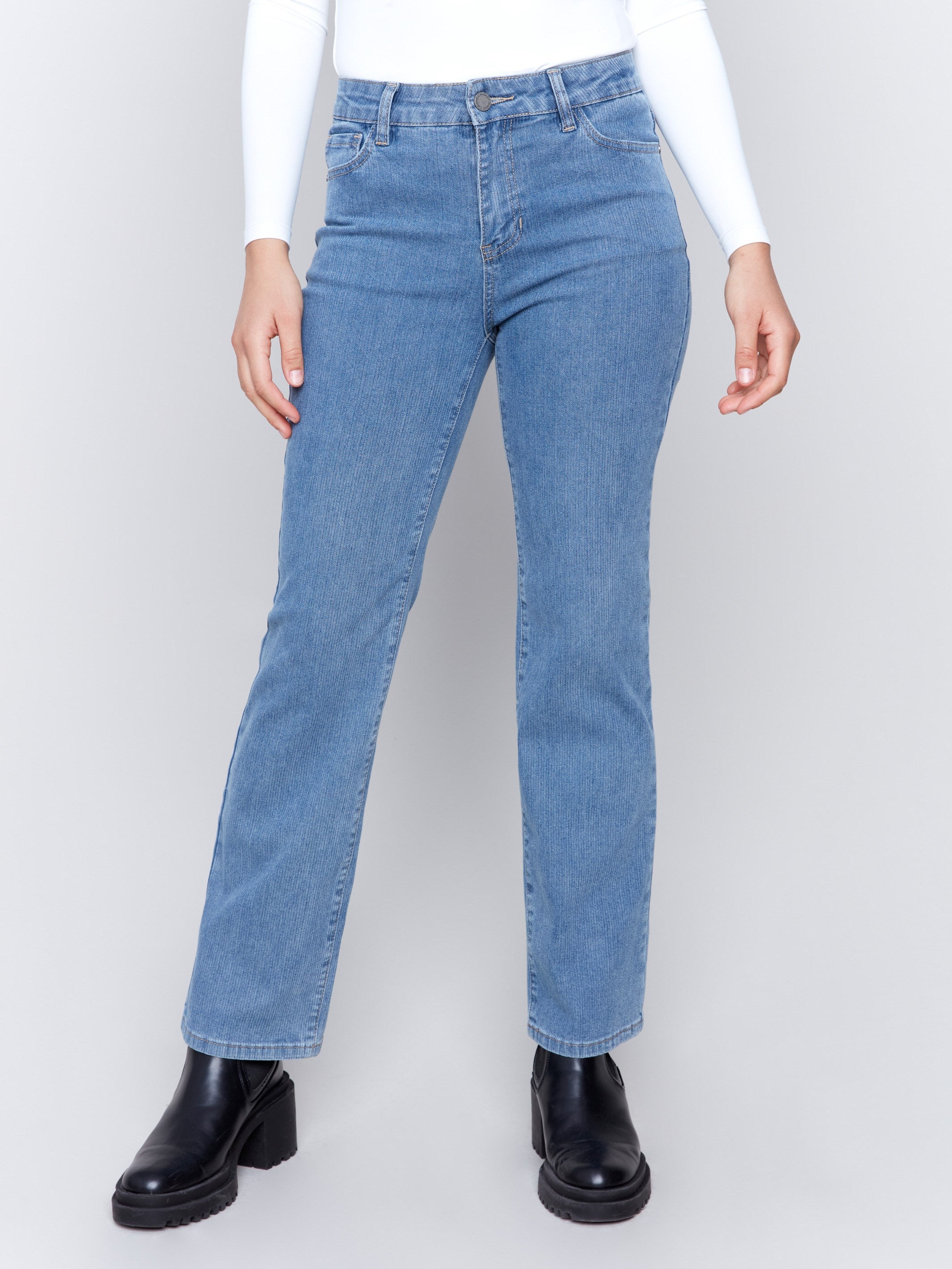 Light blue denim corduroy straight-leg pants with a five-pocket design and classic button closure by Charlie B.