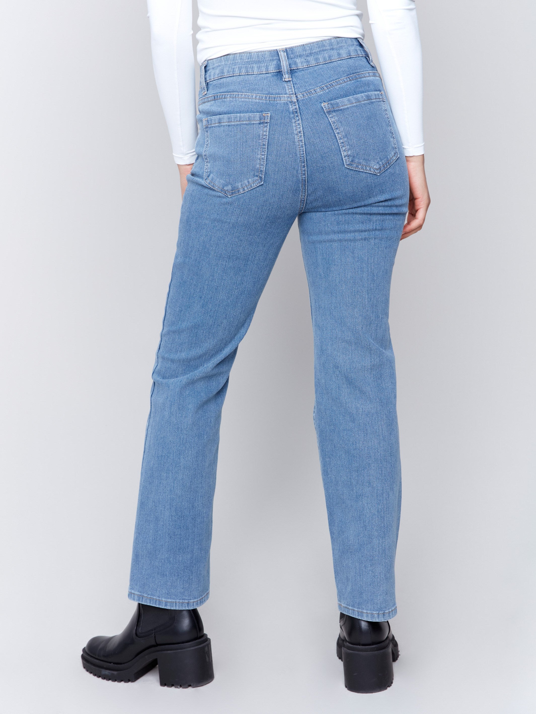 Light blue denim corduroy straight-leg pants with a five-pocket design and classic button closure by Charlie B.