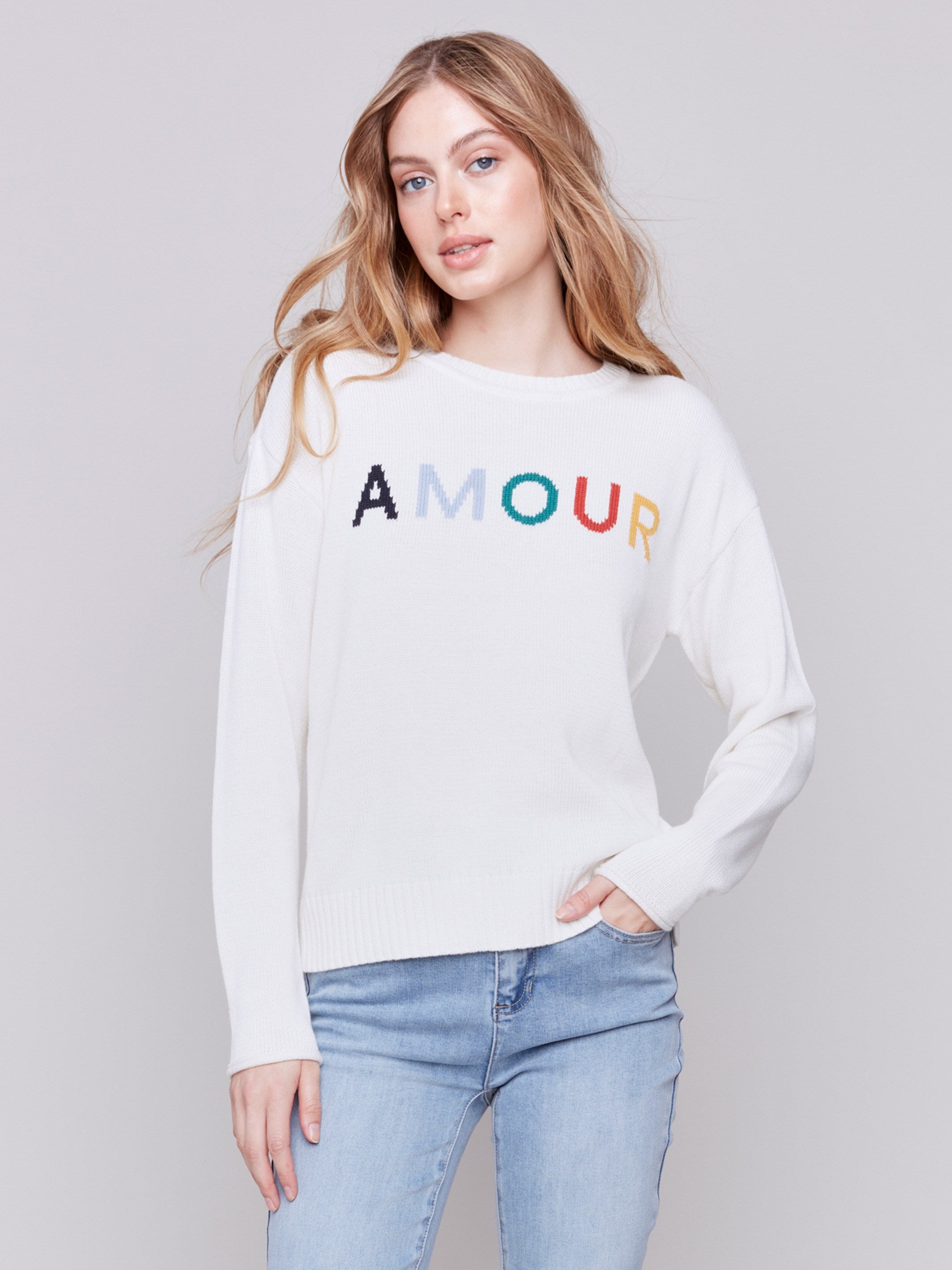 Ecru white sweater with colorful 'Amour' letters embroidered on the chest, featuring long sleeves and a crew neckline by Charlie B.