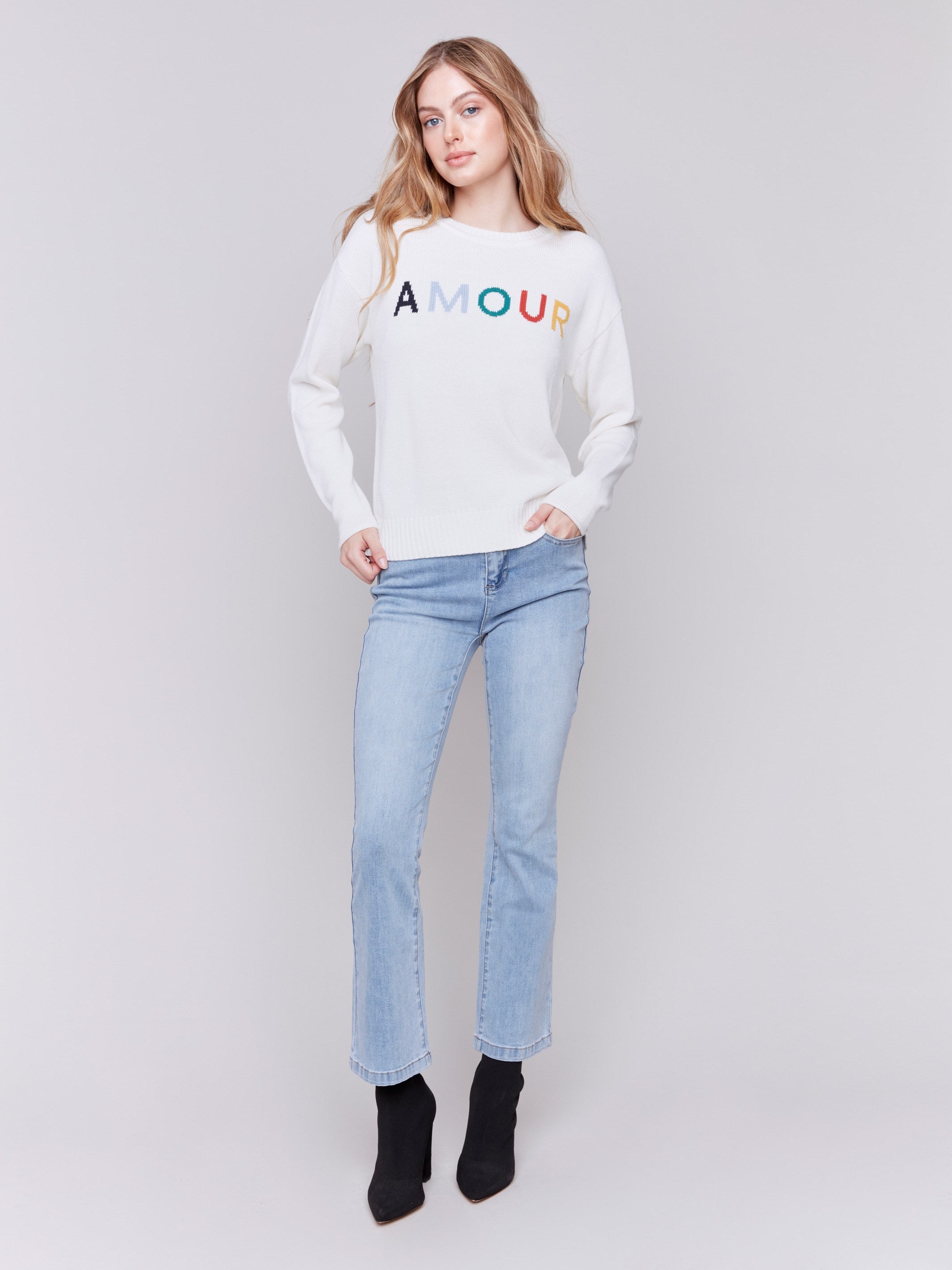 Ecru white sweater with colorful 'Amour' letters embroidered on the chest, featuring long sleeves and a crew neckline by Charlie B.