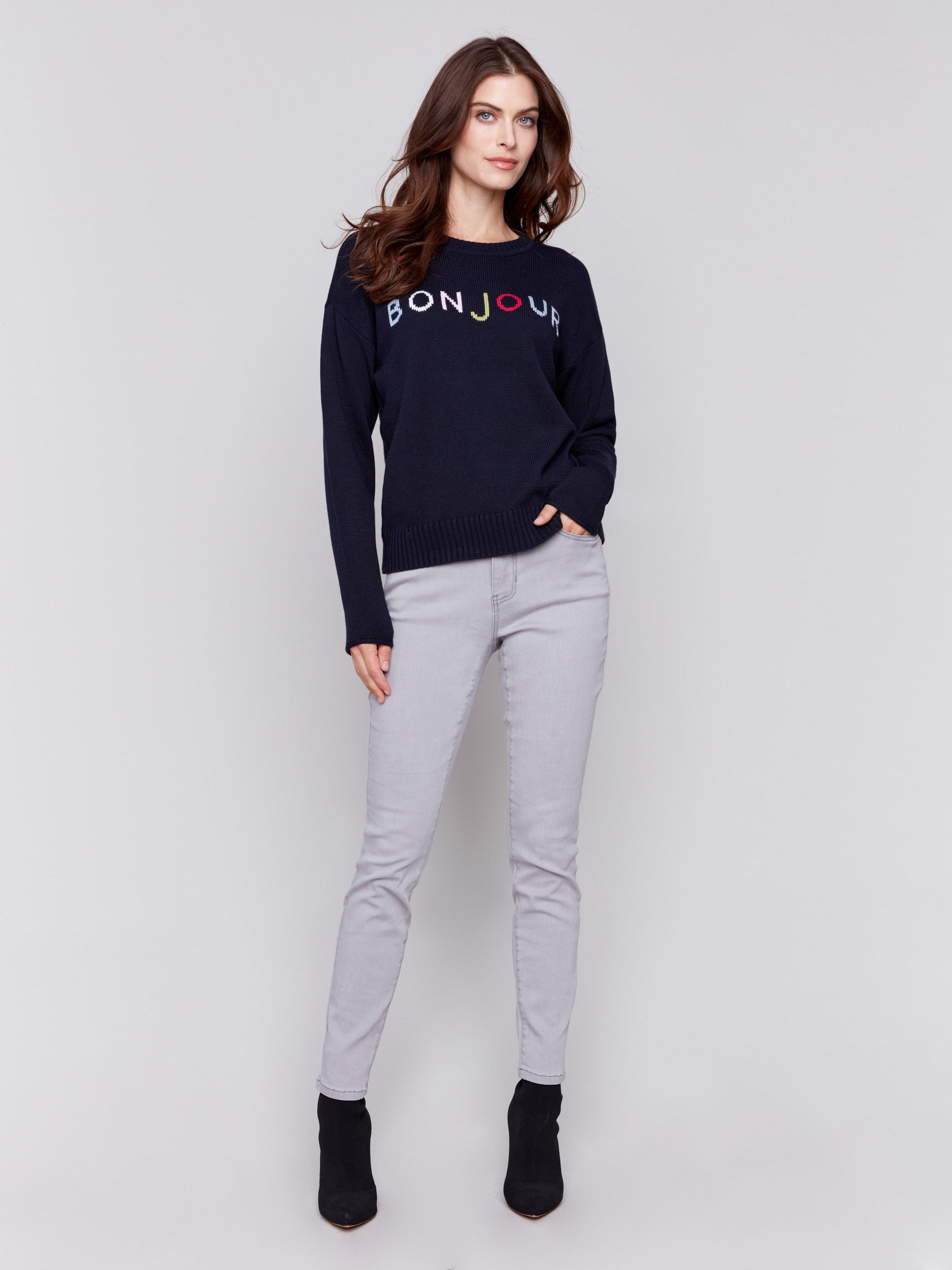 Navy sweater with colorful 'Bonjour' letters embroidered on the chest, featuring long sleeves and a crew neckline by Charlie B.