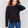 Black cotton blend sweater with white stitch detailing along the shoulders and a crew neckline by Charlie B.