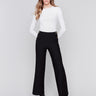 High-rise black crepe flare pants featuring decorative buttons along the waistline; sleek, elegant design perfect for formal and casual occasions, by Charlie B.