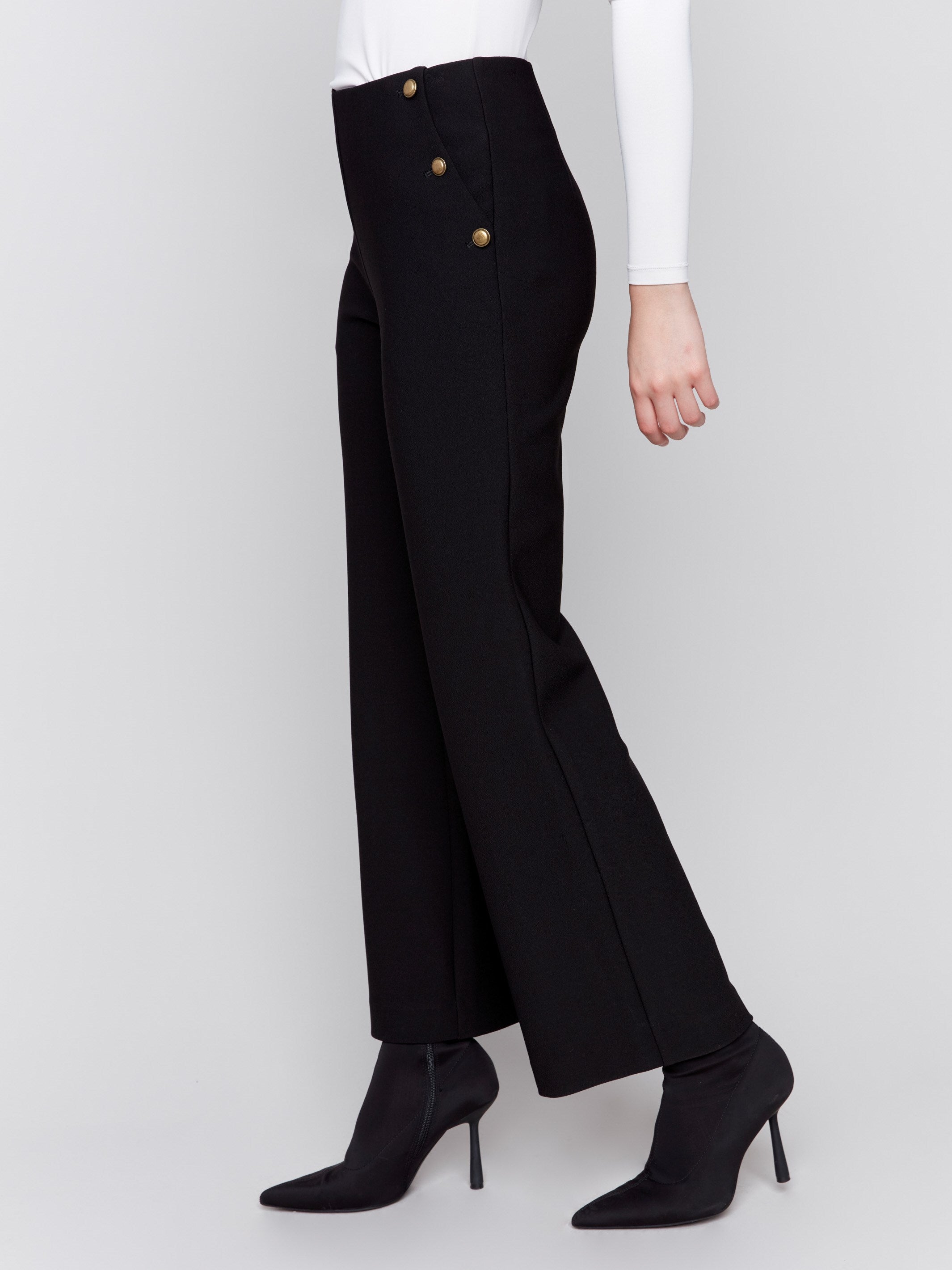 High-rise black crepe flare pants featuring decorative buttons along the waistline; sleek, elegant design perfect for formal and casual occasions, by Charlie B.