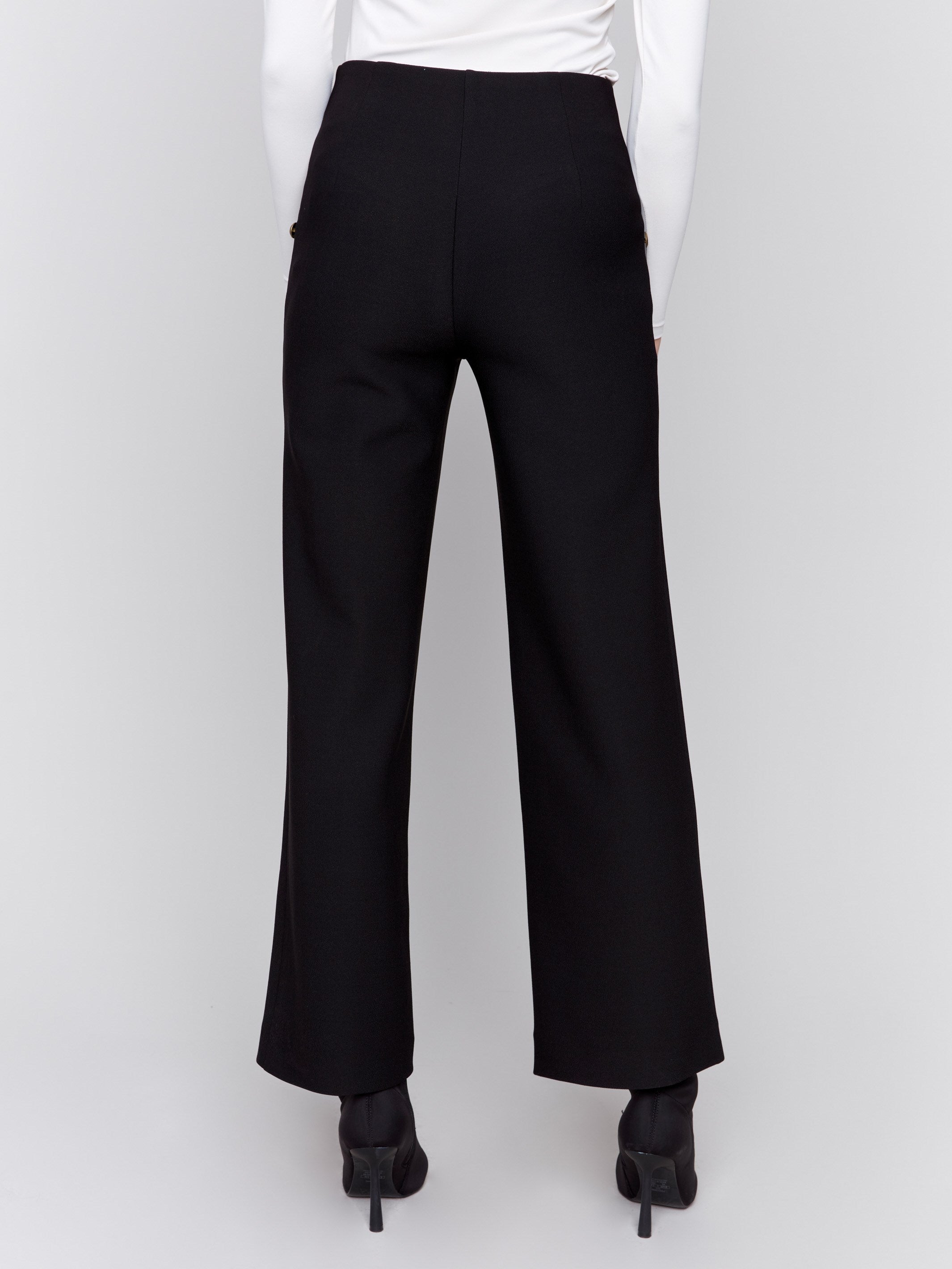 High-rise black crepe flare pants featuring decorative buttons along the waistline; sleek, elegant design perfect for formal and casual occasions, by Charlie B.