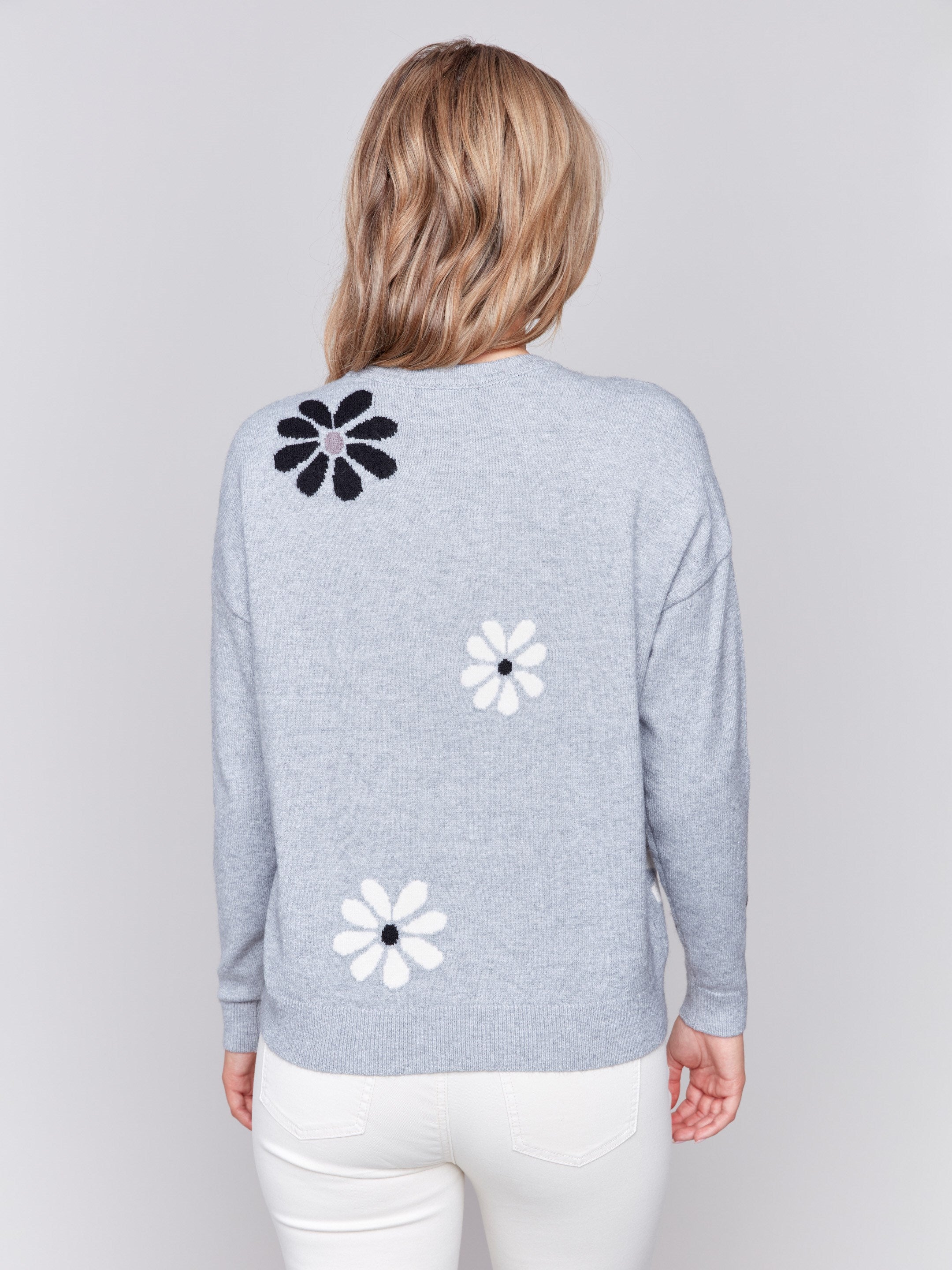 Light grey crew neck sweater with black and white floral prints featuring a drop shoulder design by Charlie B.