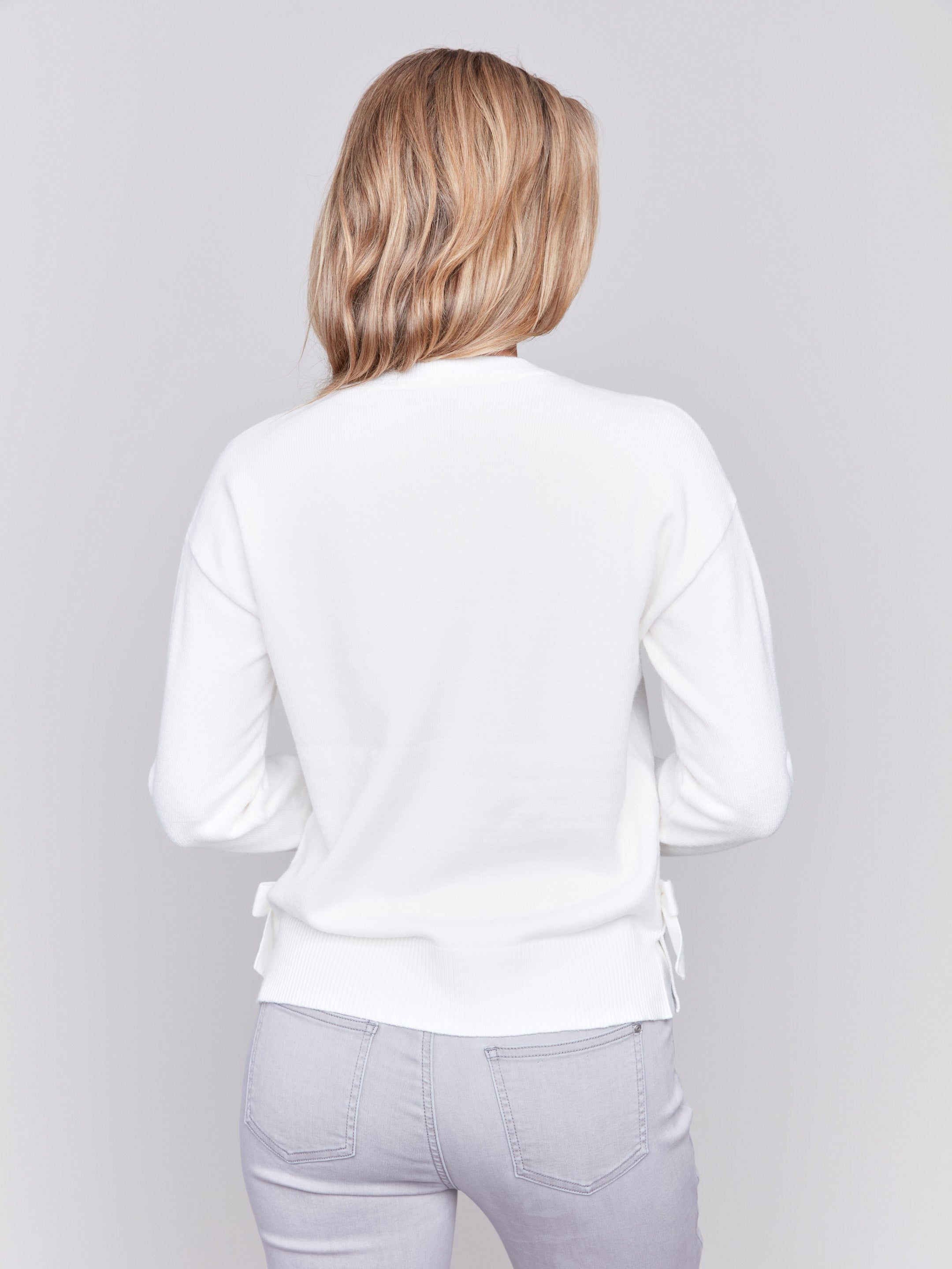 Cream long-sleeve crew neck sweater with side bow details by Charlie B.