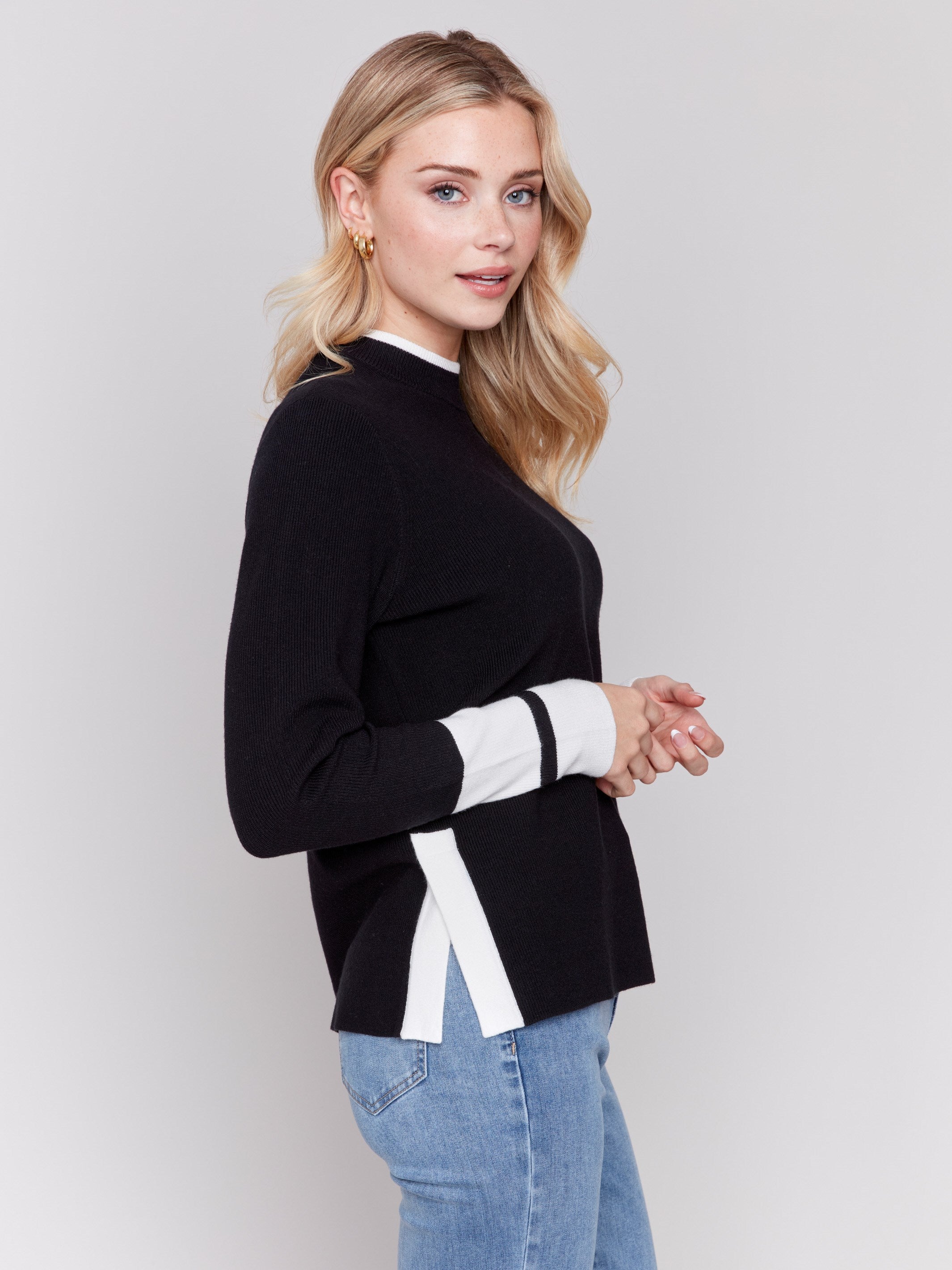 Black crew neck sweater with white accents and side slit, long sleeves, ideal for a casual look by Charlie B.