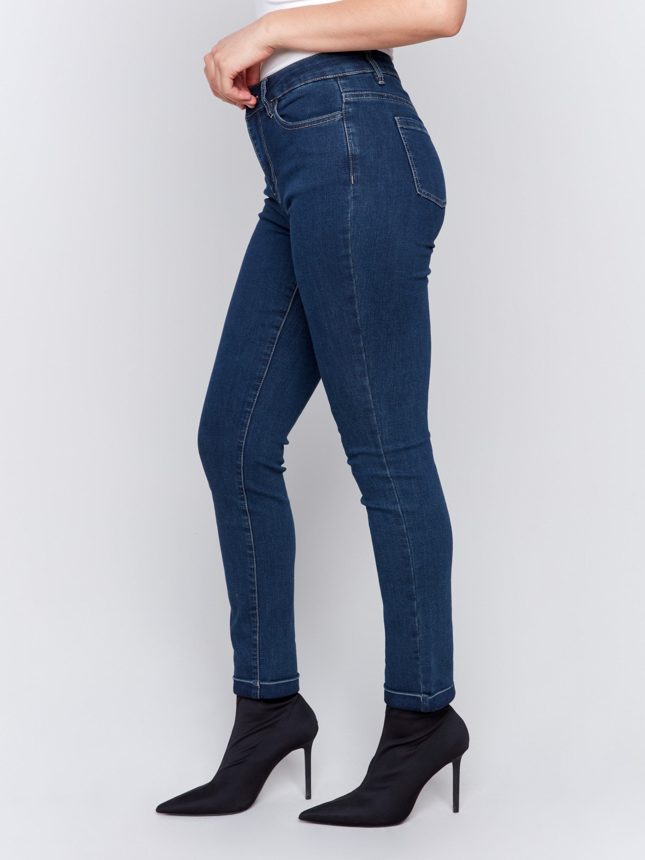 Dark blue slim-leg jeans featuring cuffed hems and a five-pocket design by Charlie B.