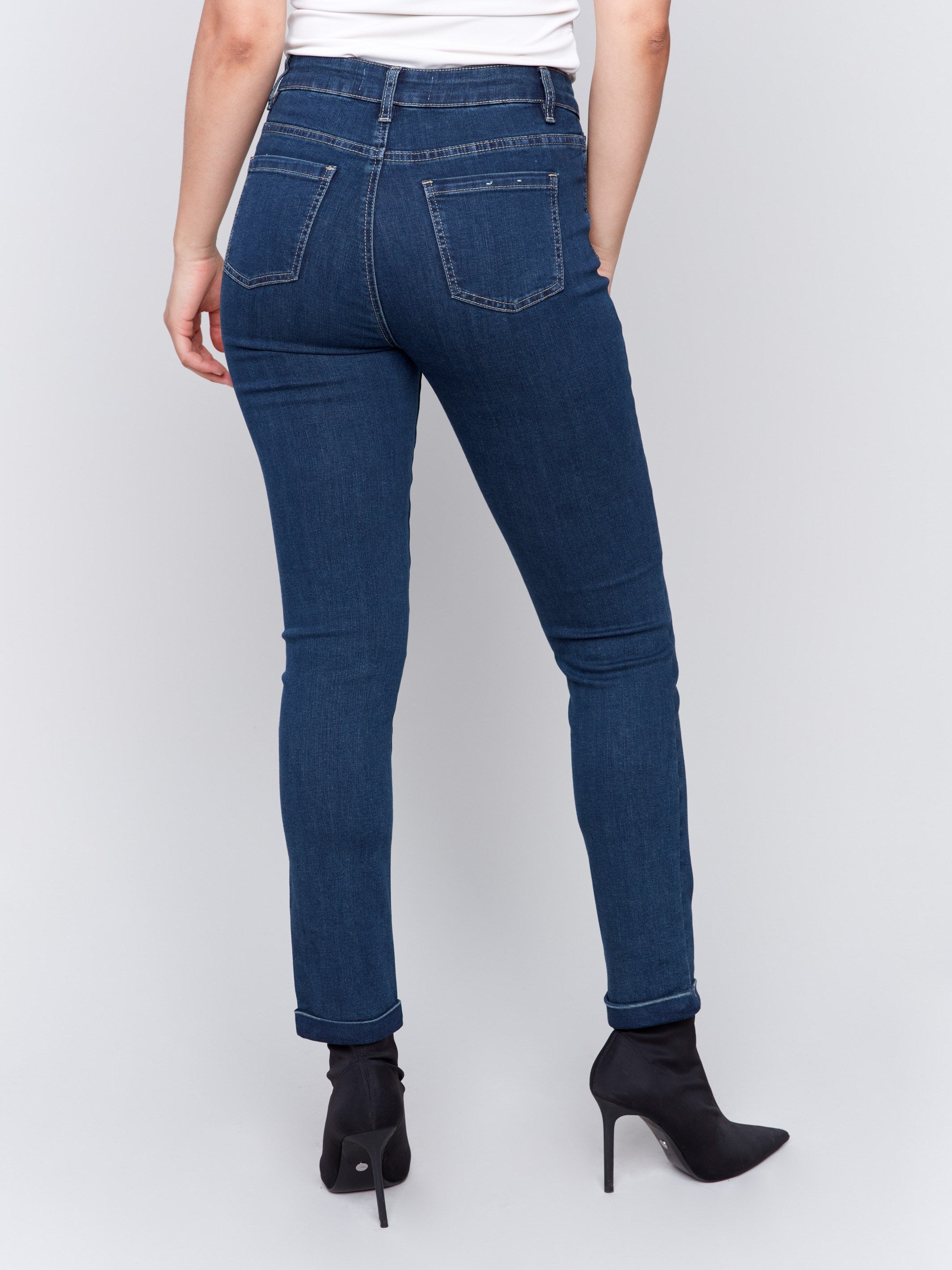 Dark blue slim-leg jeans featuring cuffed hems and a five-pocket design by Charlie B.