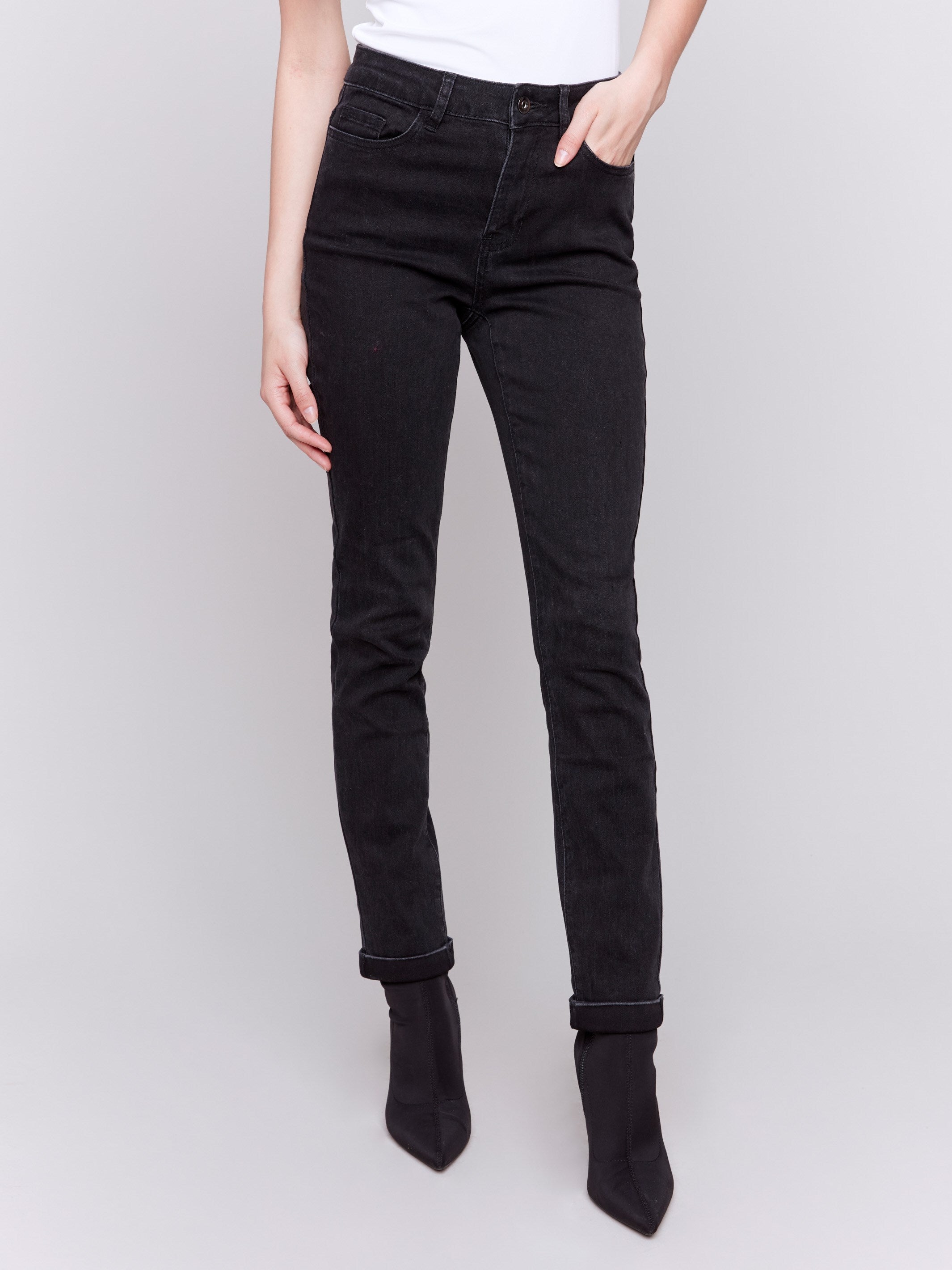 Charcoal black slim leg jeans with a cuffed hem, featuring a mid-rise and five-pocket design by Charlie B.