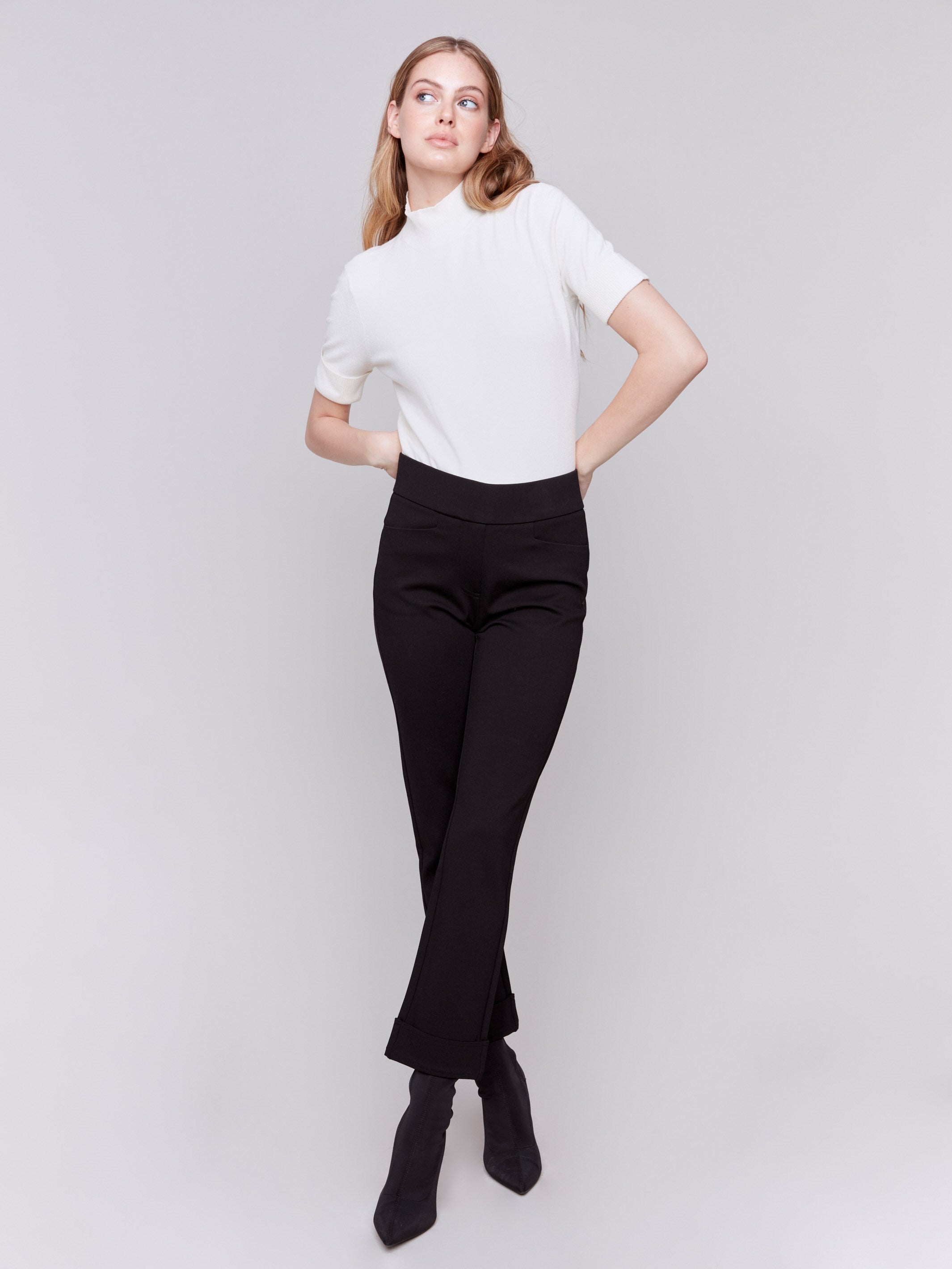 Black cuffed ponte pants featuring a straight leg fit, with welt pockets and a cuffed hem by Charlie B.