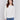 White sweater with floral embroidery, long sleeves, and a round neckline by Charlie B.