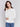 White sweater with floral embroidery, long sleeves, and a round neckline by Charlie B.