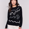 Black jacquard knit sweater featuring abstract embroidery and a round hemline by Charlie B.