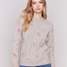 Cozy Almond beige sweater with floral embroidery, featuring long sleeves and a crew neckline by Charlie B.