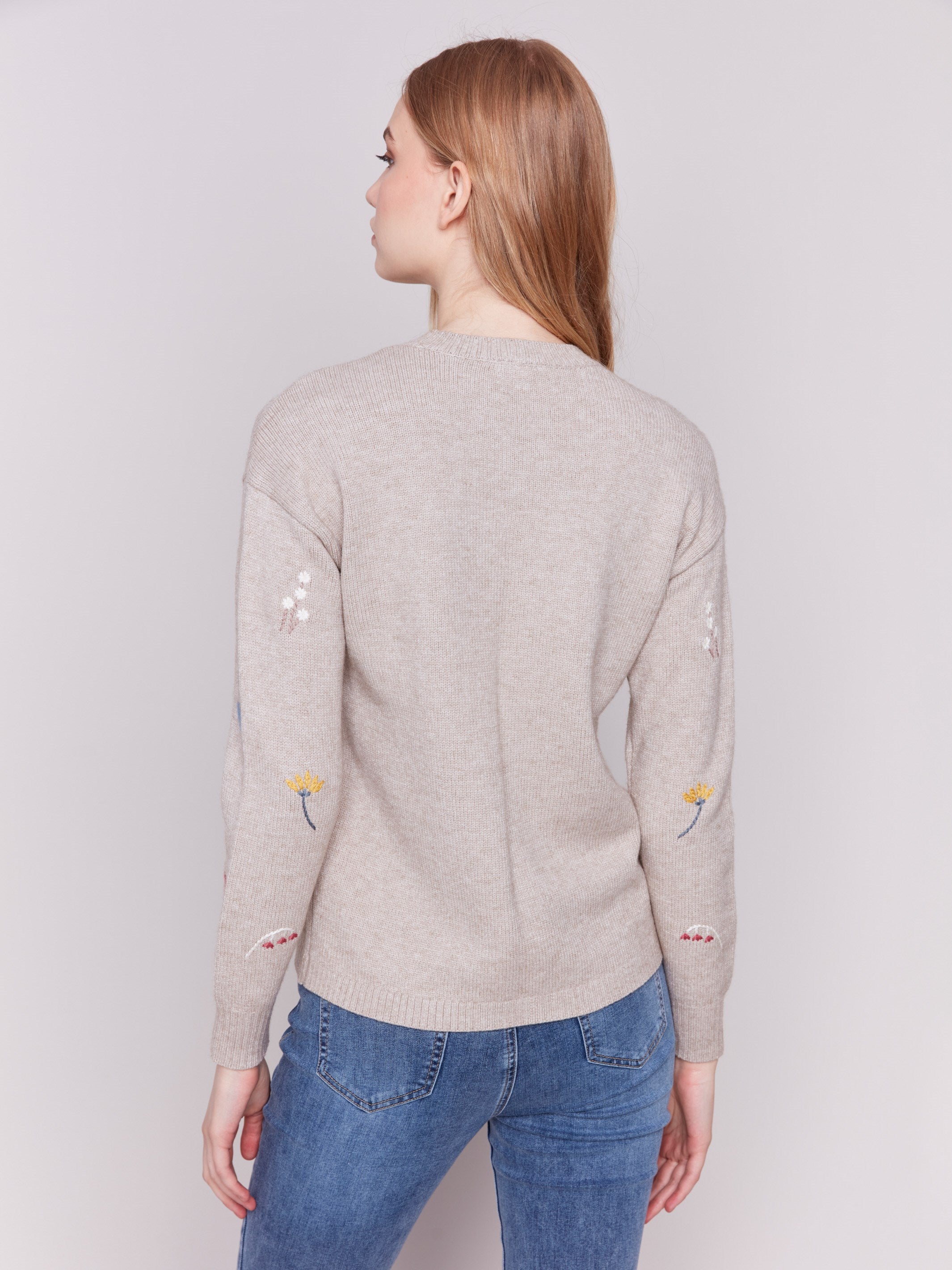 Cozy Almond beige sweater with floral embroidery, featuring long sleeves and a crew neckline by Charlie B.