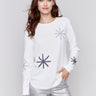 Ecru whitelong-sleeve sweater with snowflake embroidery and rounded hem by Charlie B.