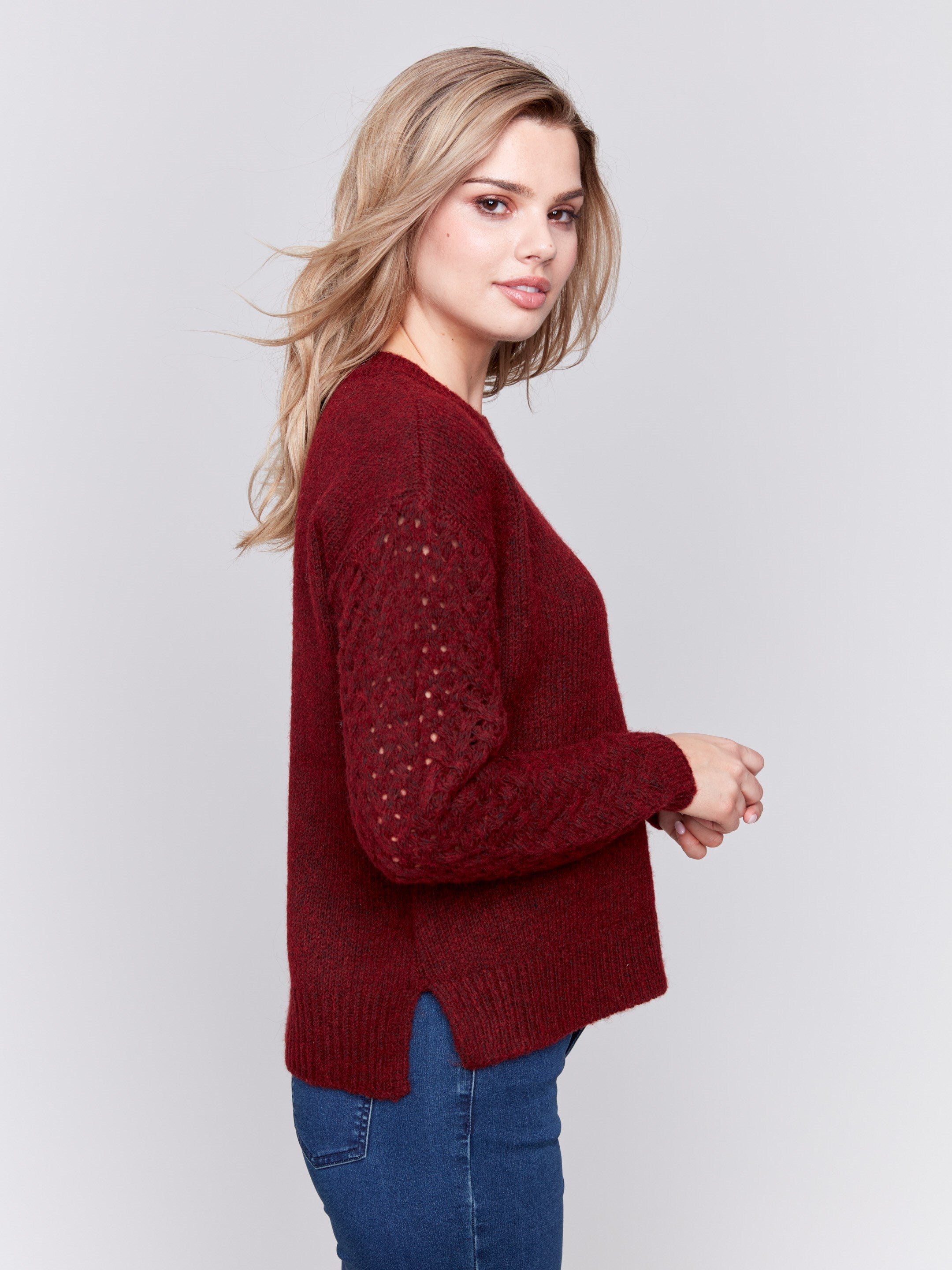 Cabernet red crew neck sweater with fishnet sleeves, offering a plushy knit texture, designed by Charlie B.