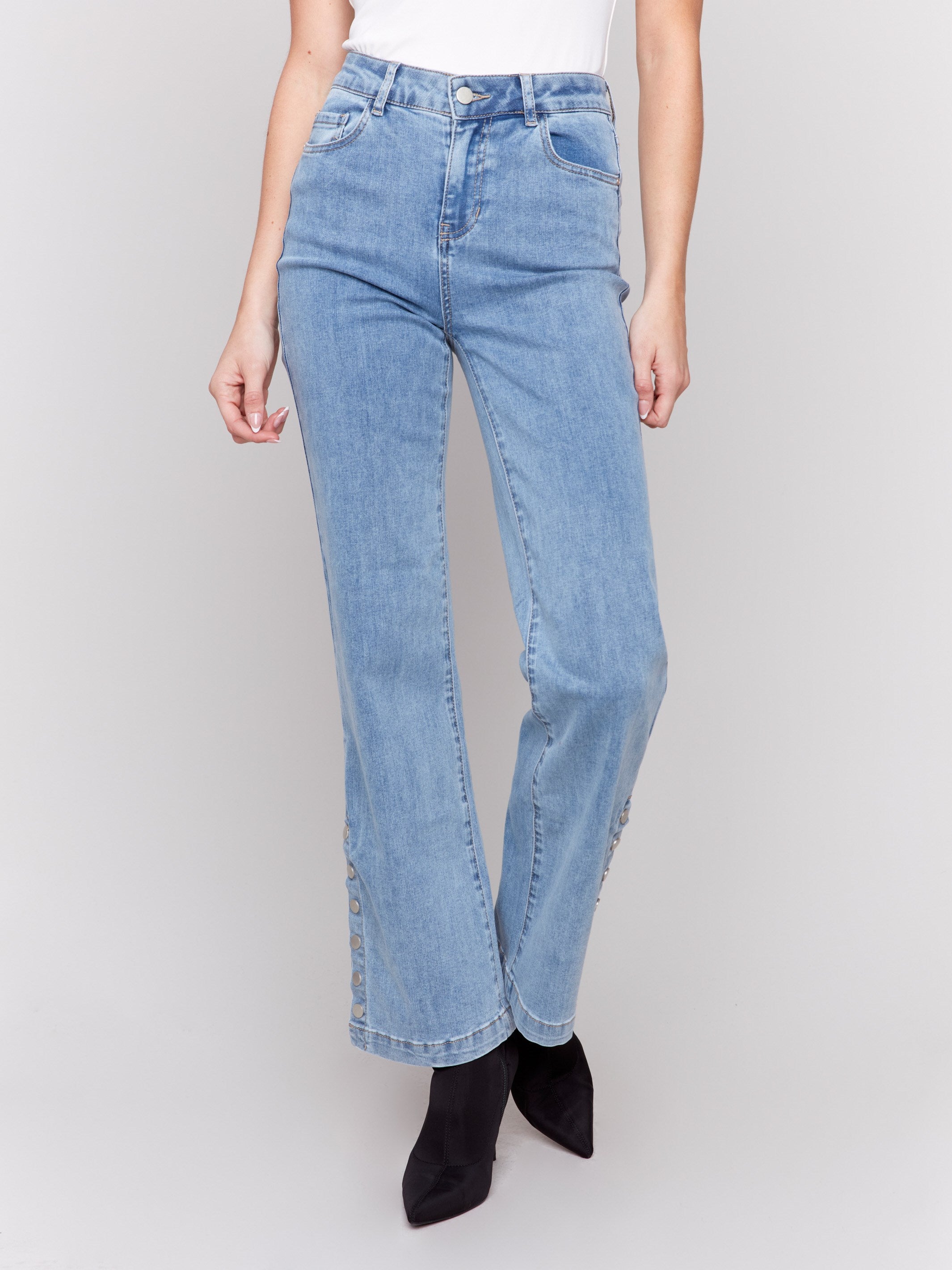 Light blue flare jeans with side button detailing, featuring a regular rise and classic five-pocket design by Charlie B.