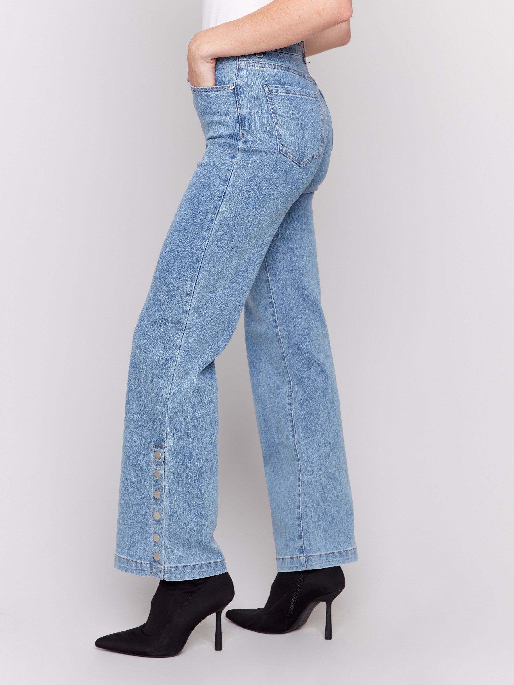 Light blue flare jeans with side button detailing, featuring a regular rise and classic five-pocket design by Charlie B.