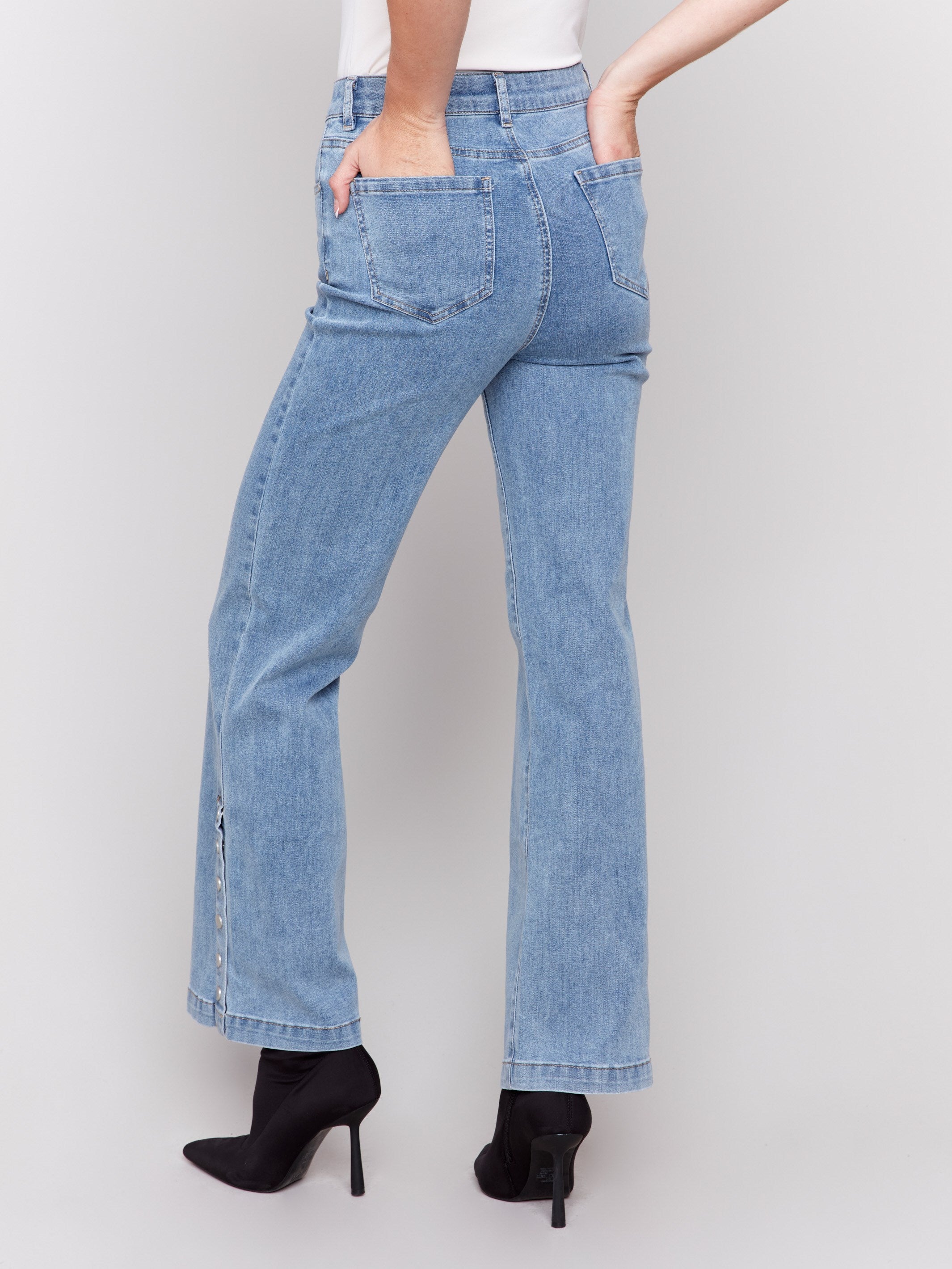 Light blue flare jeans with side button detailing, featuring a regular rise and classic five-pocket design by Charlie B.