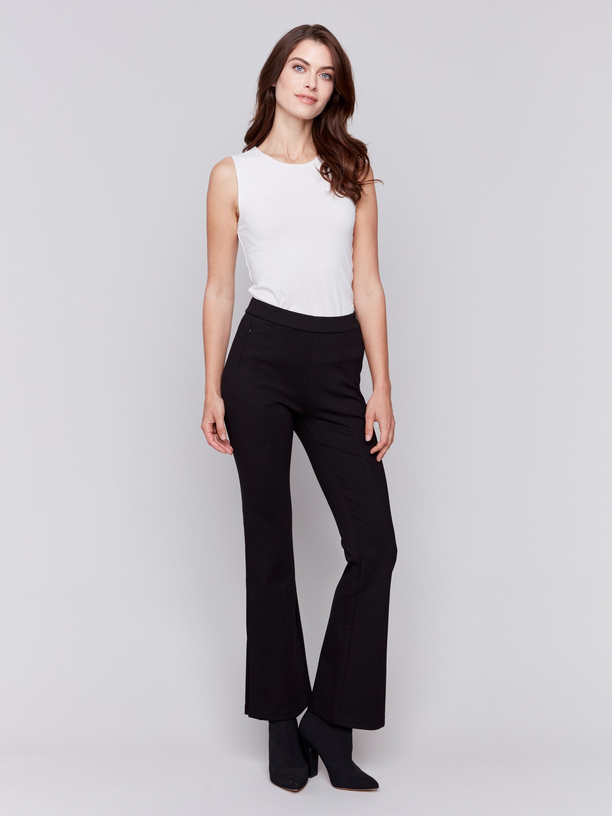 Woman wearing black flare ponte pants with side slits by Charlie B.