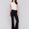 Woman wearing black flare ponte pants with side slits by Charlie B.