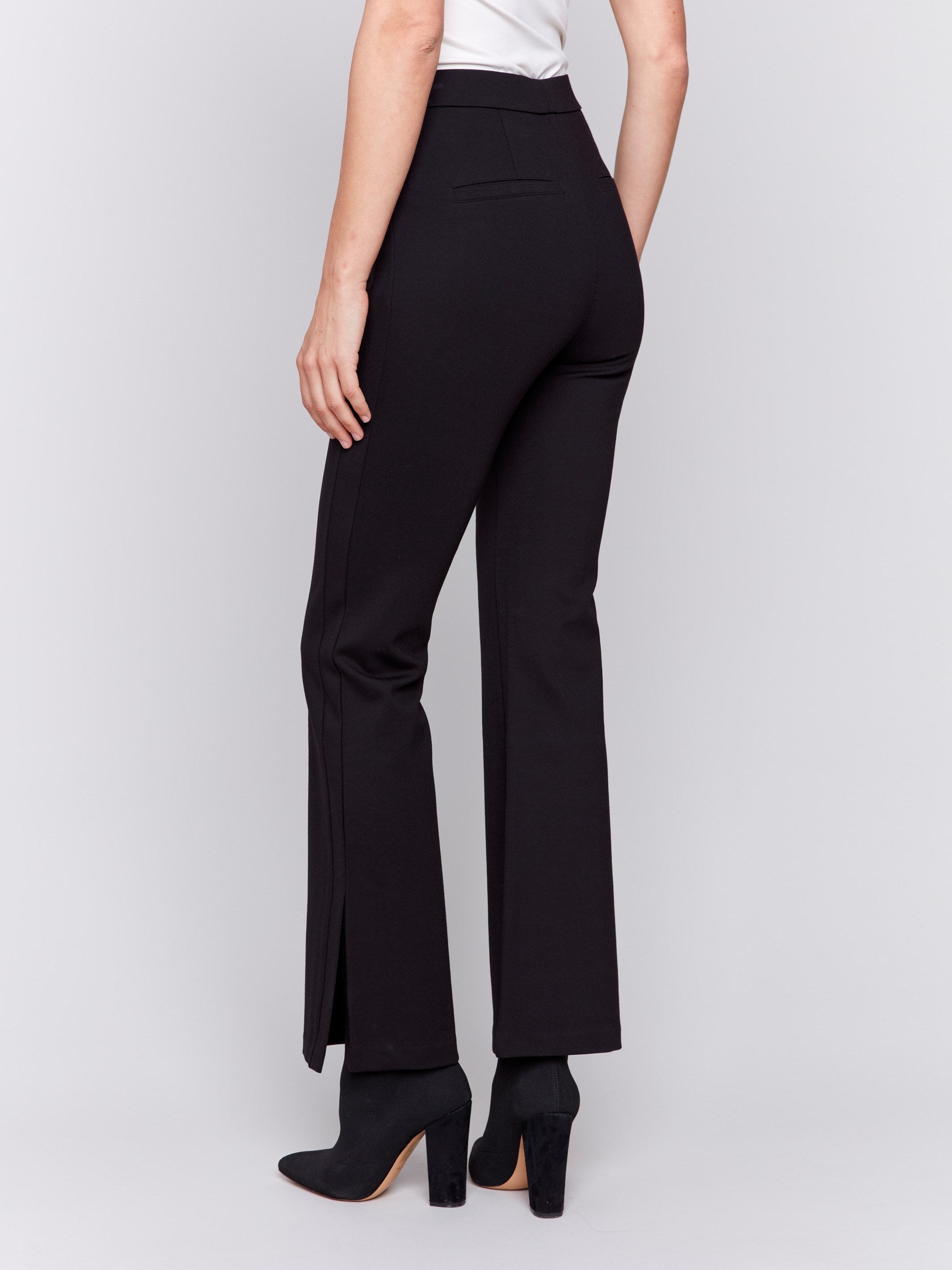 Woman wearing black flare ponte pants with side slits by Charlie B.