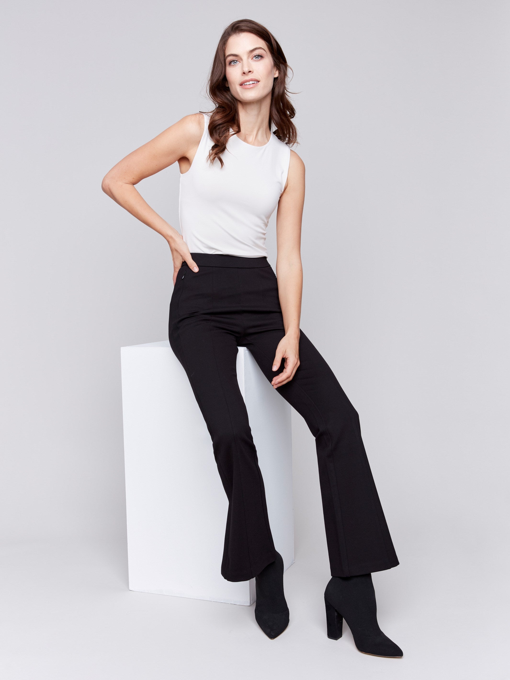 Woman wearing black flare ponte pants with side slits by Charlie B.