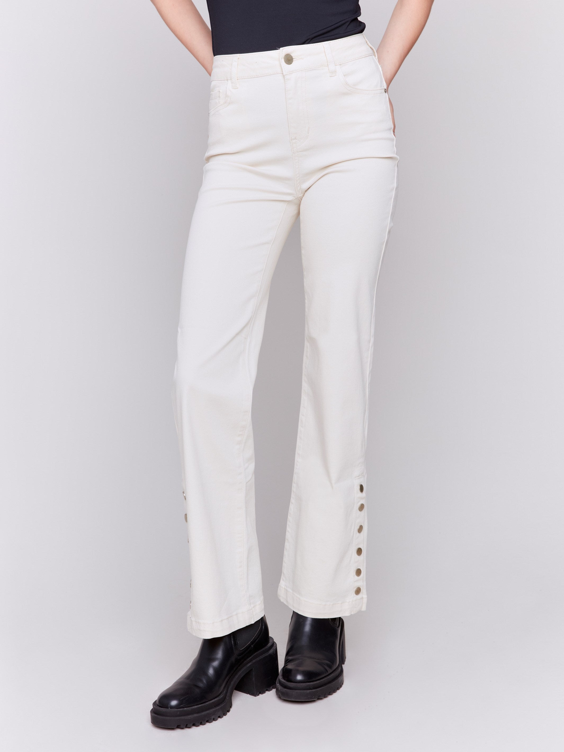 Natural white tone flare twill jeans with side buttons, featuring a five-pocket design and button closure by Charlie B.